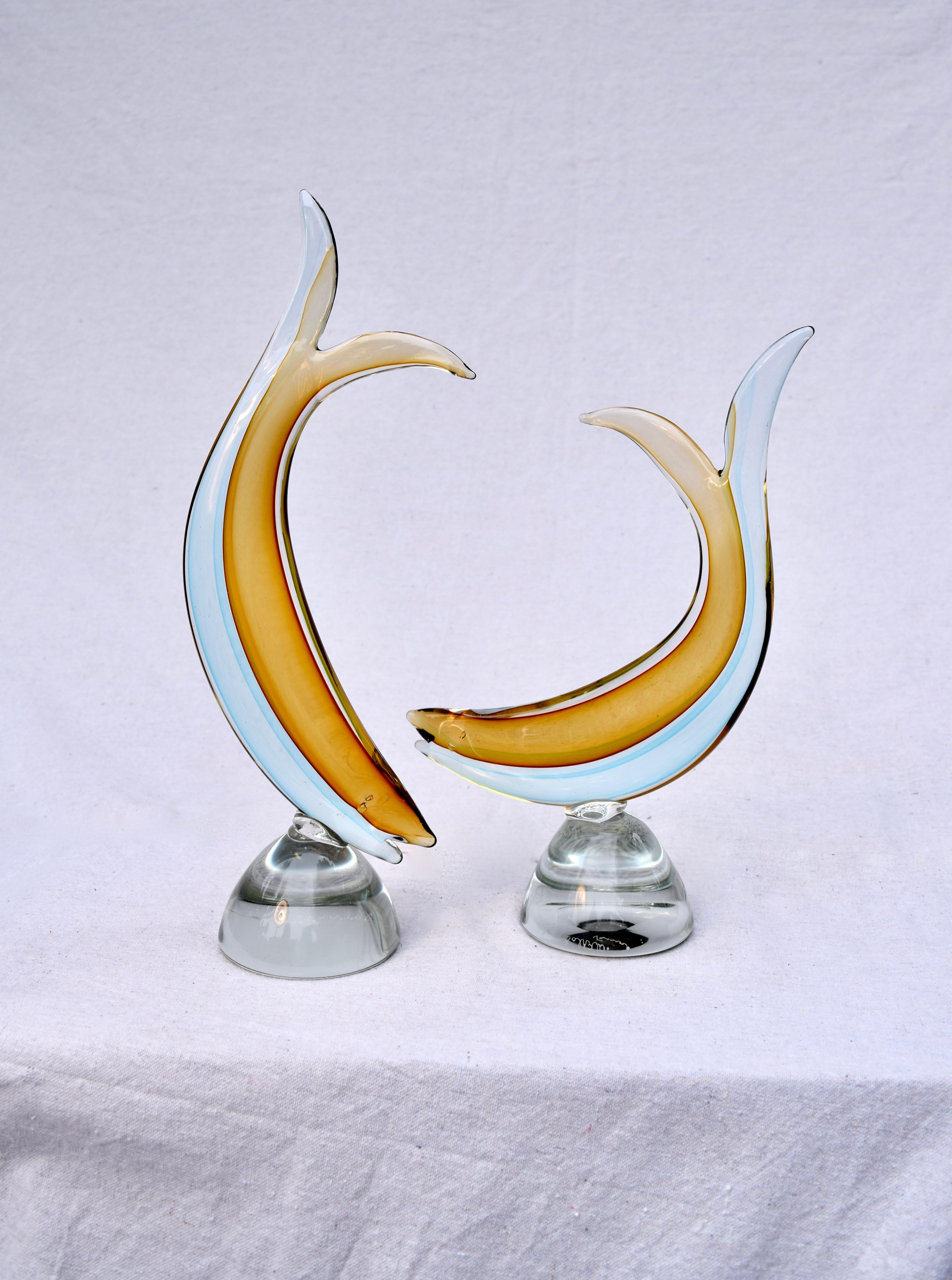 A pair of Salviati Venezia studio fish Sculptures of Sommerso form, clear, over aqua blue and amber layers of thick Murano glass. Each is hand signed Salviati, Venezia. 15