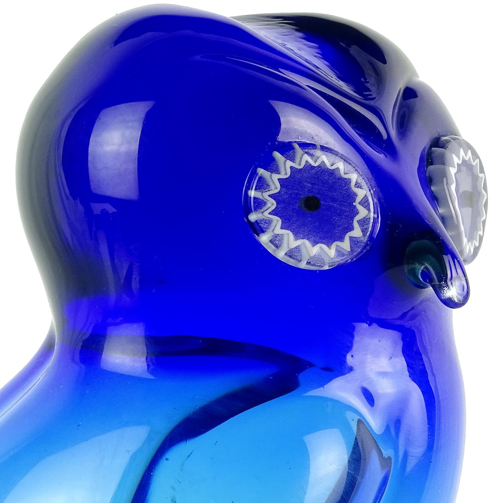 Beautiful Murano hand blown Sommerso cobalt blue Italian art glass owl sculpture. Documented to the Salviati Company. It has white murrines for the eyes and stands on clear glass pedestal. Measures: 8 1/4” tall.
Also available in Amber, see last