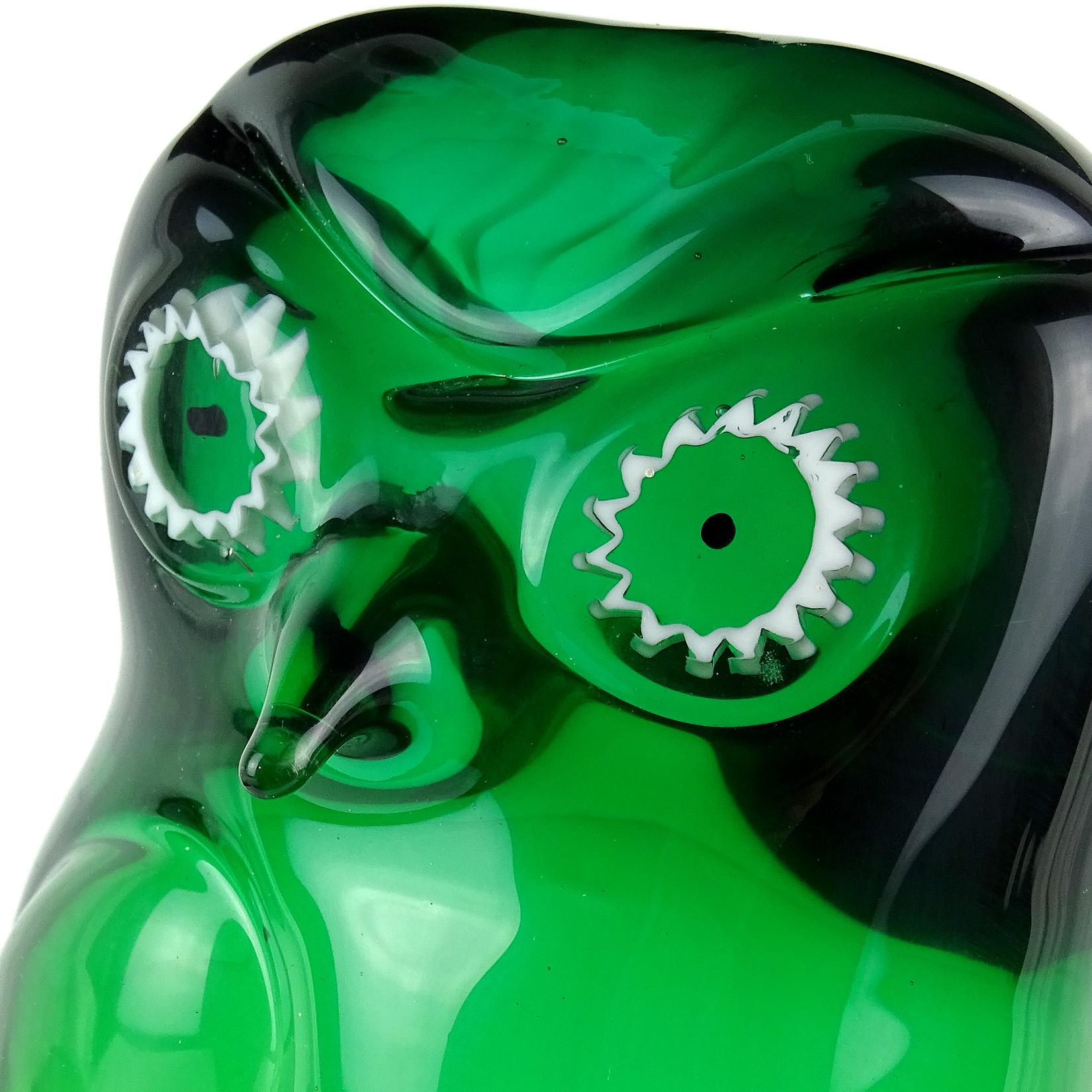 Beautiful Murano hand blown Sommerso green Italian art glass owl sculpture. Documented to the Salviati Company. It has white murrines for the eyes and stands on clear glass pedestal. Original Salviati gallery label underneath. Measures 8 3/4”