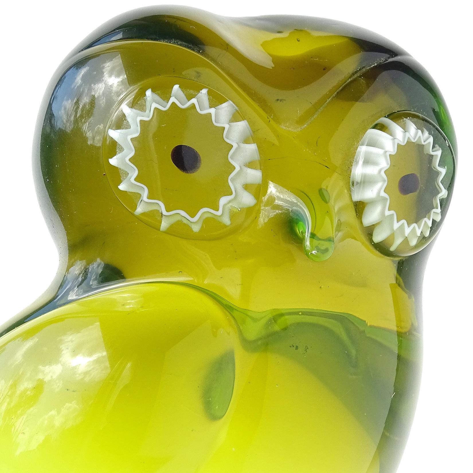 Beautiful vintage Murano hand blown Sommerso olive green to bright green Italian art glass owl sculpture. Documented to the Salviati Company, with original label still attached underneath. It has white murrines for the eyes and stands on clear glass