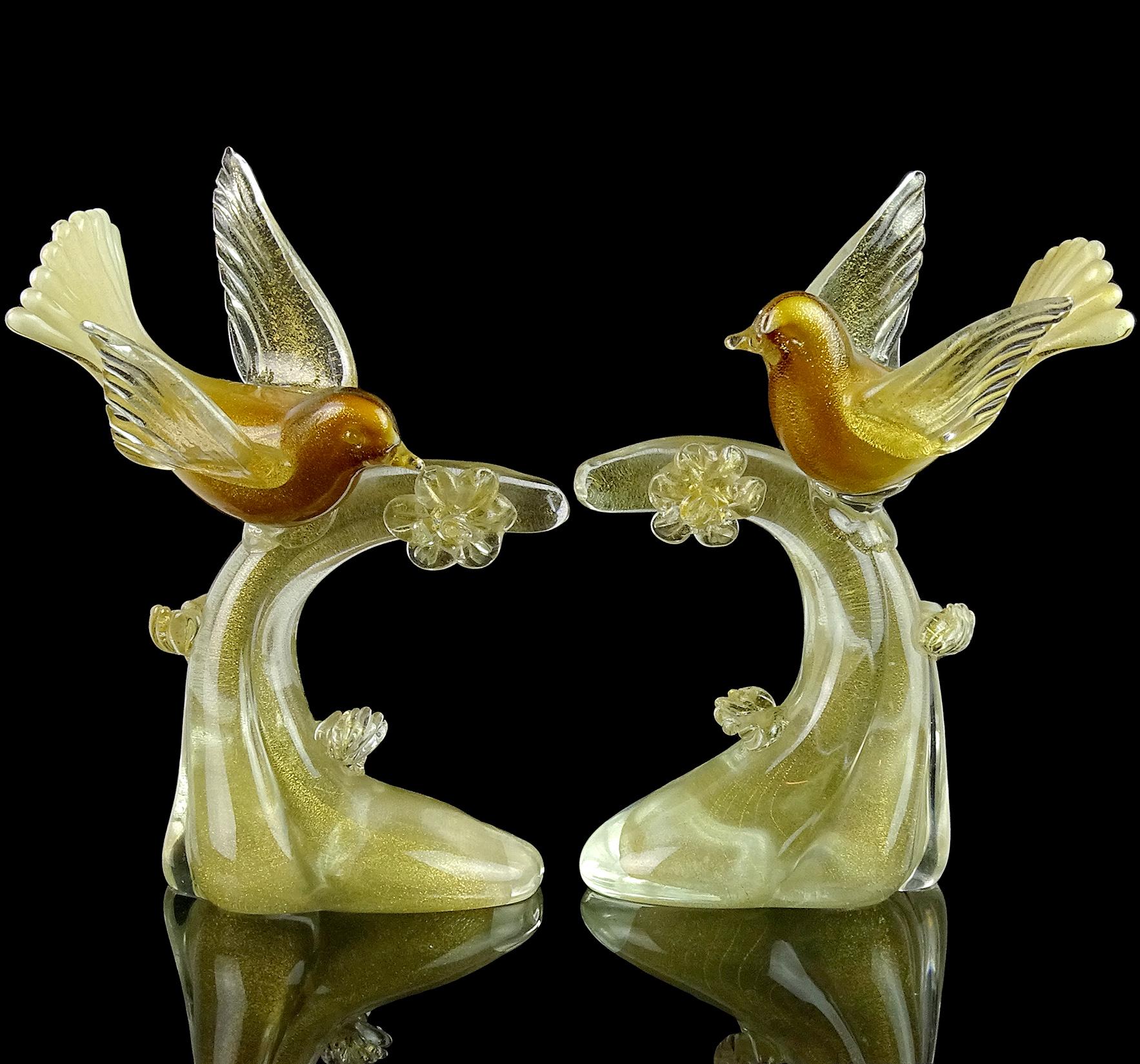 Murano vintage, and gorgeous, hand blown white, deep golden amber and gold flecks Italian art glass playful birds on branch sculptures. They are a matched pair. The birds are documented to the Salviati company, with original worn label underneath.