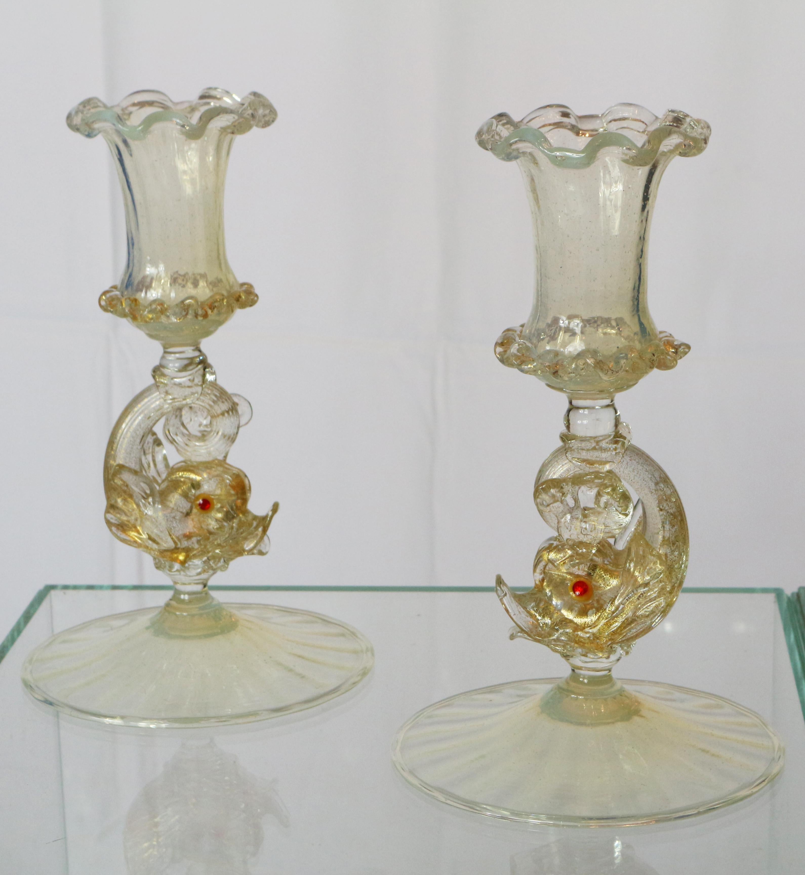 Pair of early-20th gold opal venetian candlestick by A.Salviati.

Antonio Salviati founded in 1866 a blown glass factory, the Venice and Murano company limited. This was a period of research for the Murano master and among the many techniques taken