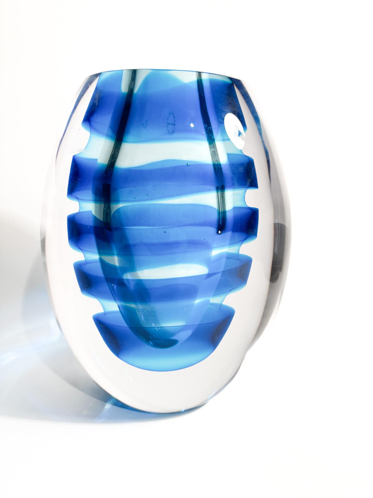 Elliptical vase in submerged Murano glass with blue spirals, made by Salviati in 2003.

Ø 17 cm Ø 12 cm h 21 cm

Salviati is a prestigious glass manufacturer based in Murano, Venice, Italy. Founded in 1859, it is one of the oldest and most respected