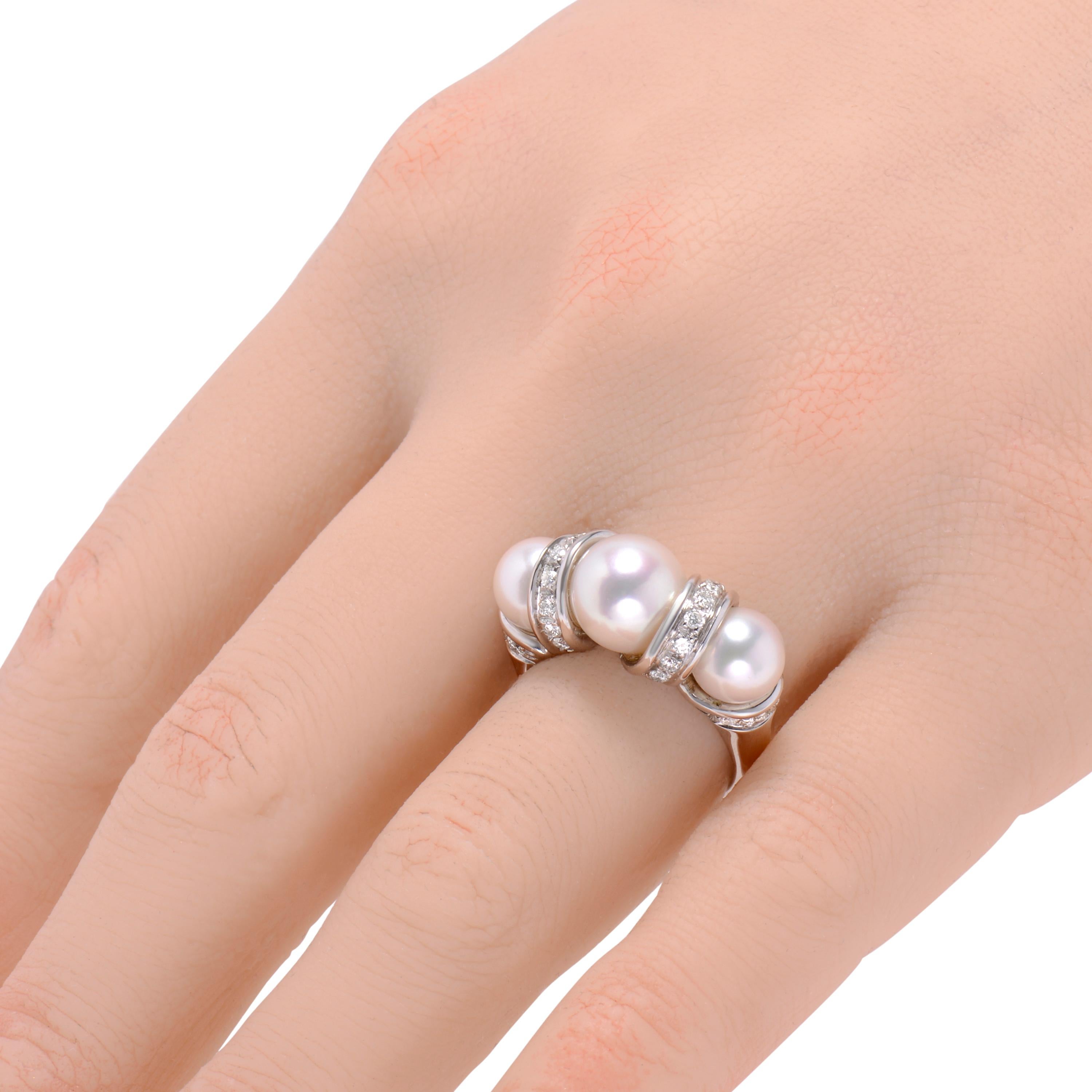 This unique Salvini 18K white gold statement ring features shimmering diamonds (0.45ct twd) enhancing a luscious decoration of pearls (8.5mm, 7mm). The ring size is 6. The band width is 1mm. The weight is 9.6g.
