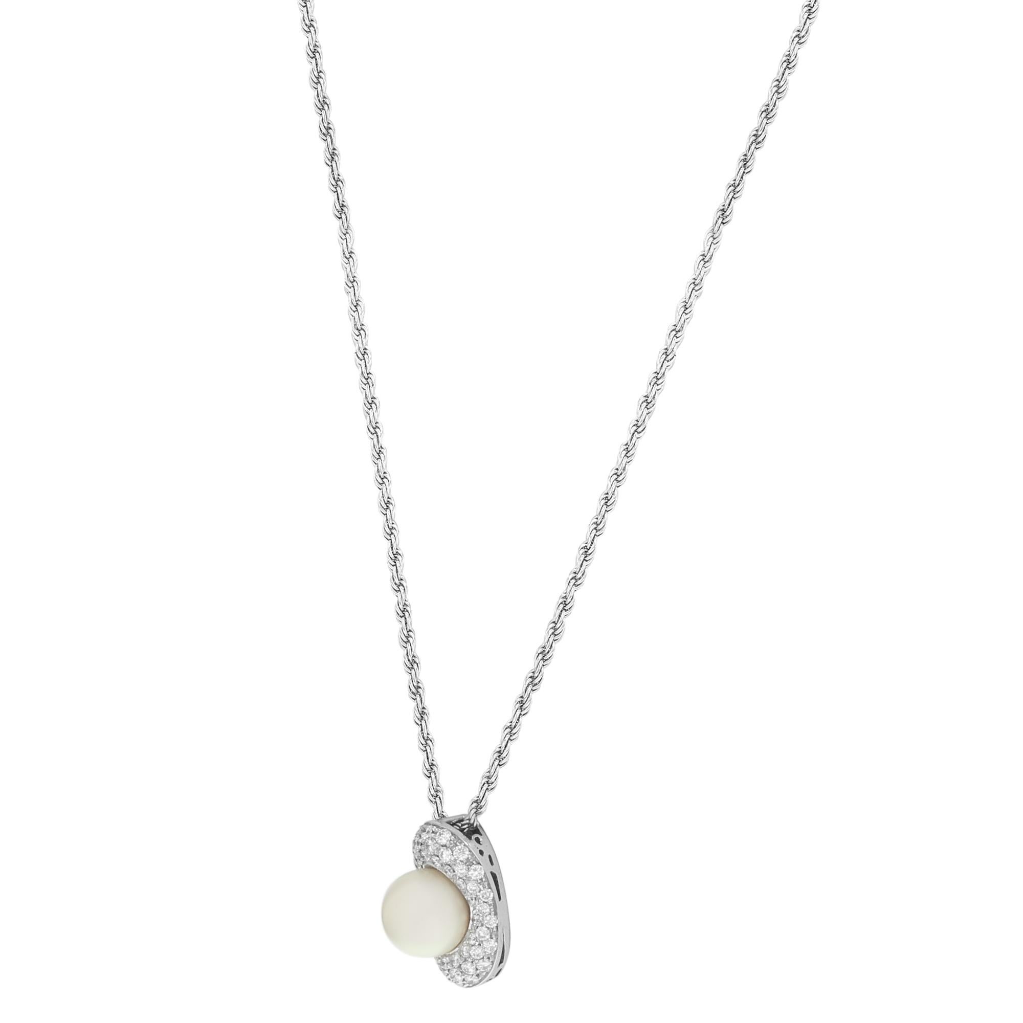 This stunning diamond and pearl pendant necklace is crafted in 18k white gold and encrusted with 0.65 carat diamonds & pearl. Length of the necklace is 18.75