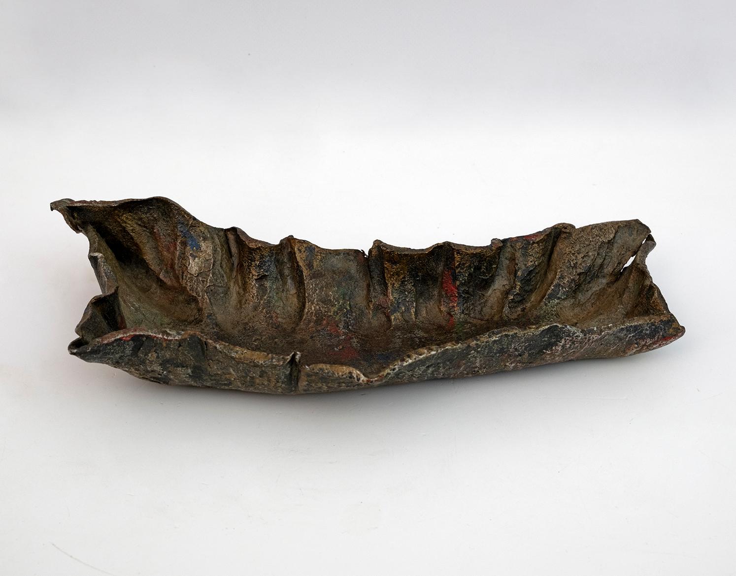One-of-a-kind brutalist and sculptural coin tray, designed and built in Italy in the 1970s by the Italian sculptor Salvino Marsura.
In hand-forged iron, silver patinated with camouflage touches.
This artistic centerpiece is signed by the artist and