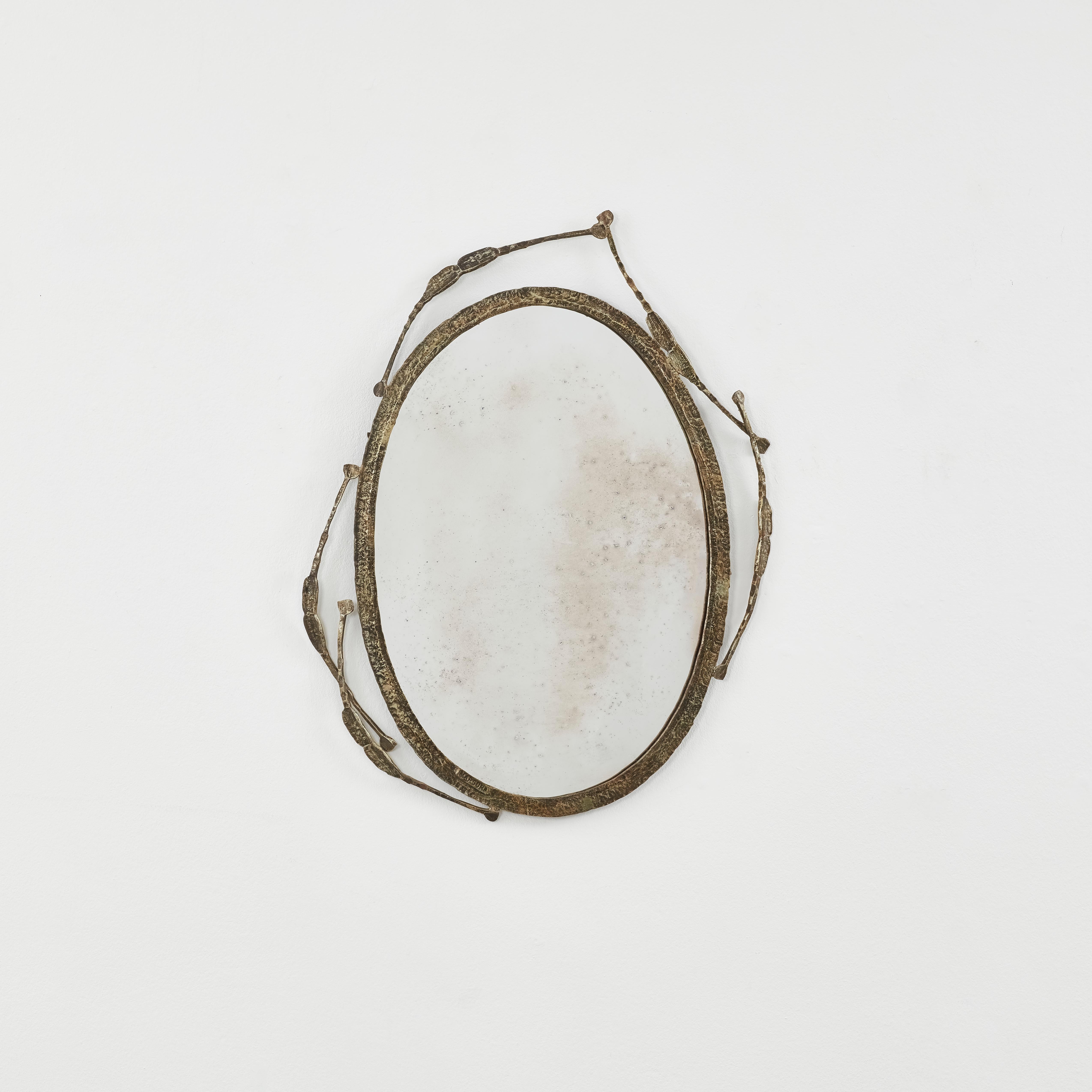 Curves of organic forms, like dandelion seeds, circle asymmetrically across this highly textured and tactile wrought iron mirror, featuring colour powdered pigments. 

The iron mirror frame features patination true to its age, and a new mirror has