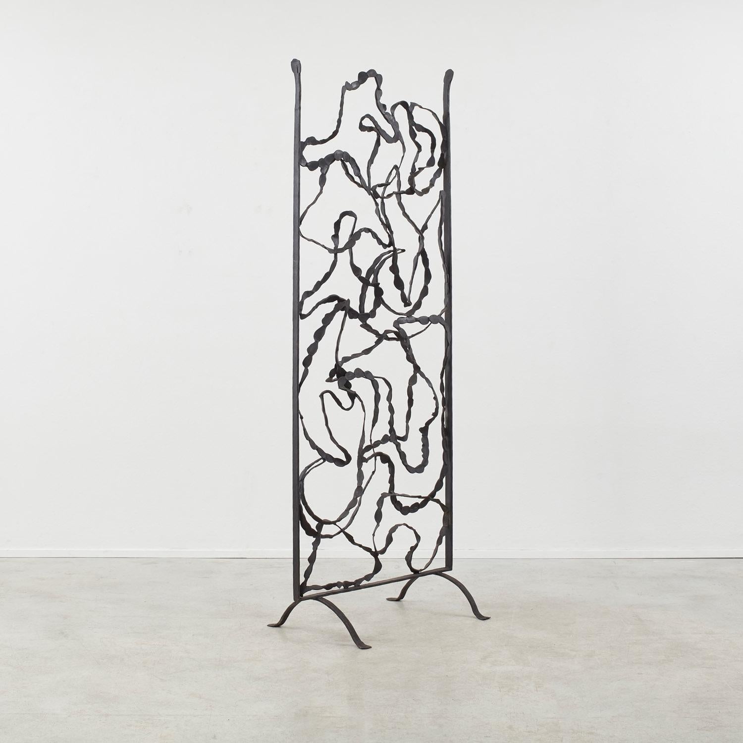 Bending, curling lines of iron lattice skein together in this room divider. A fluid, evocative piece, the Pannello Divisorio is as much about the negative shapes cast within its frame as it is about its wrought surfaces.

The room divider rests on