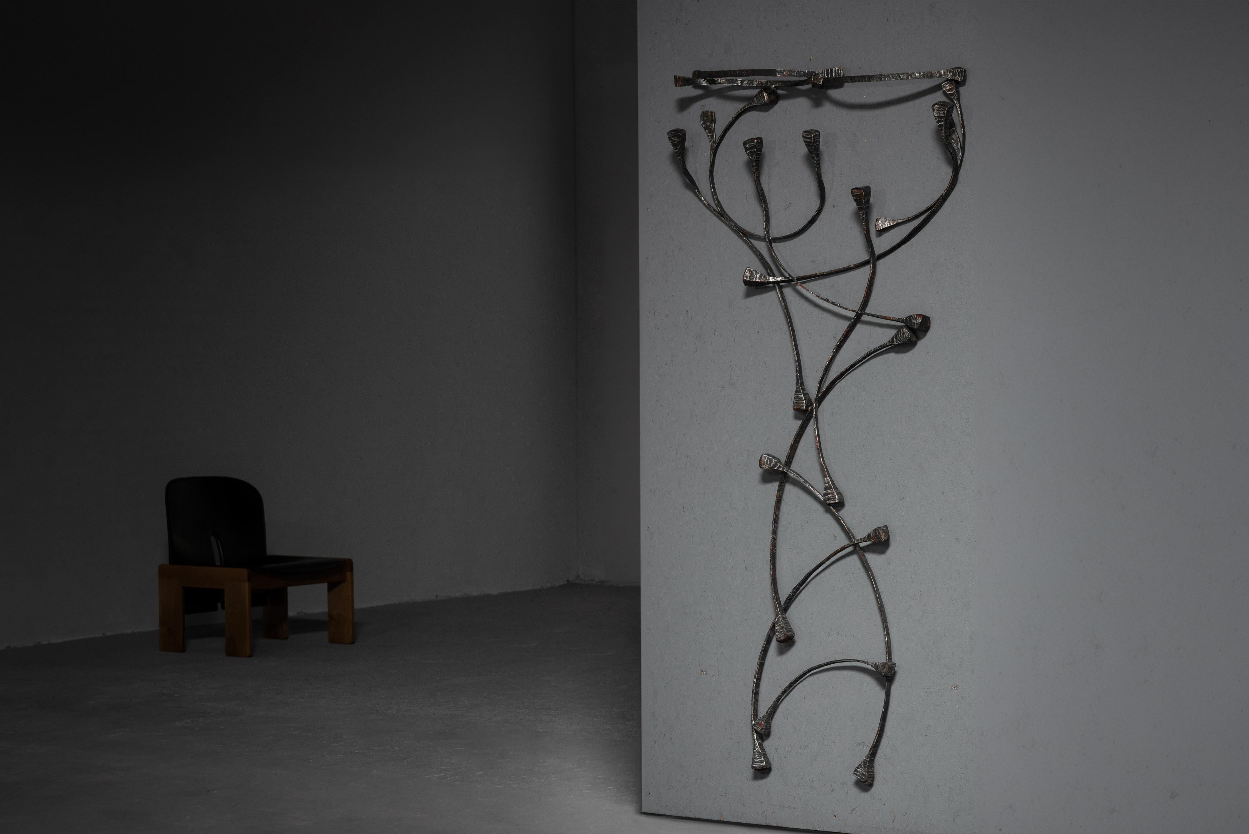 Sculptural coat rack designed by Salvino Marsura and made in his own atelier in Italy in 1970. This coat rack is both a work of art as a functional piece made from wrought iron that's been meticulously hammered and welded, resulting in a strikingly