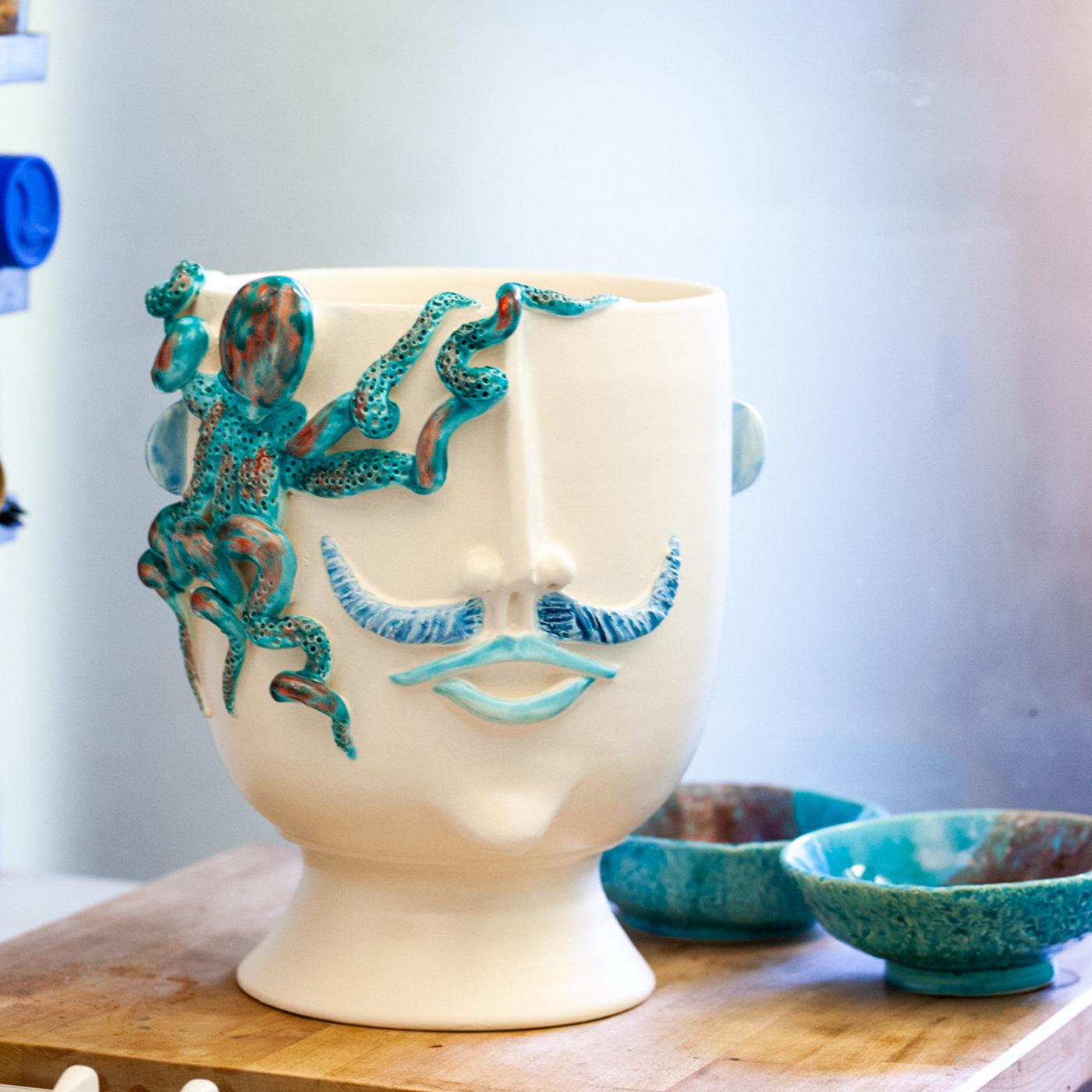 An ideal piece to accent coastal decors, this sophisticated design in fine matte white ceramic is simultaneously a vessel and a simply decorative anthropomorphic head. It showcases a male face - inspired by Salvo, a street vendor of octopus (