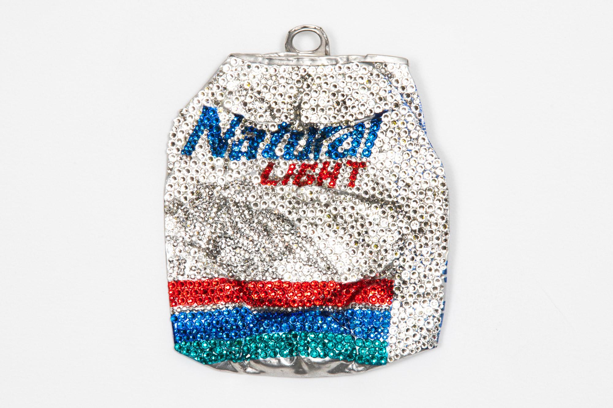 Sculpture made from Swarovski crystals and a found, car-flattened “Natural Light” beer can by Los Angeles-based artist Sam Keller. The backside is signed and features a D-ring anchor for hanging. This piece was featured in Sam Keller's 2023 solo
