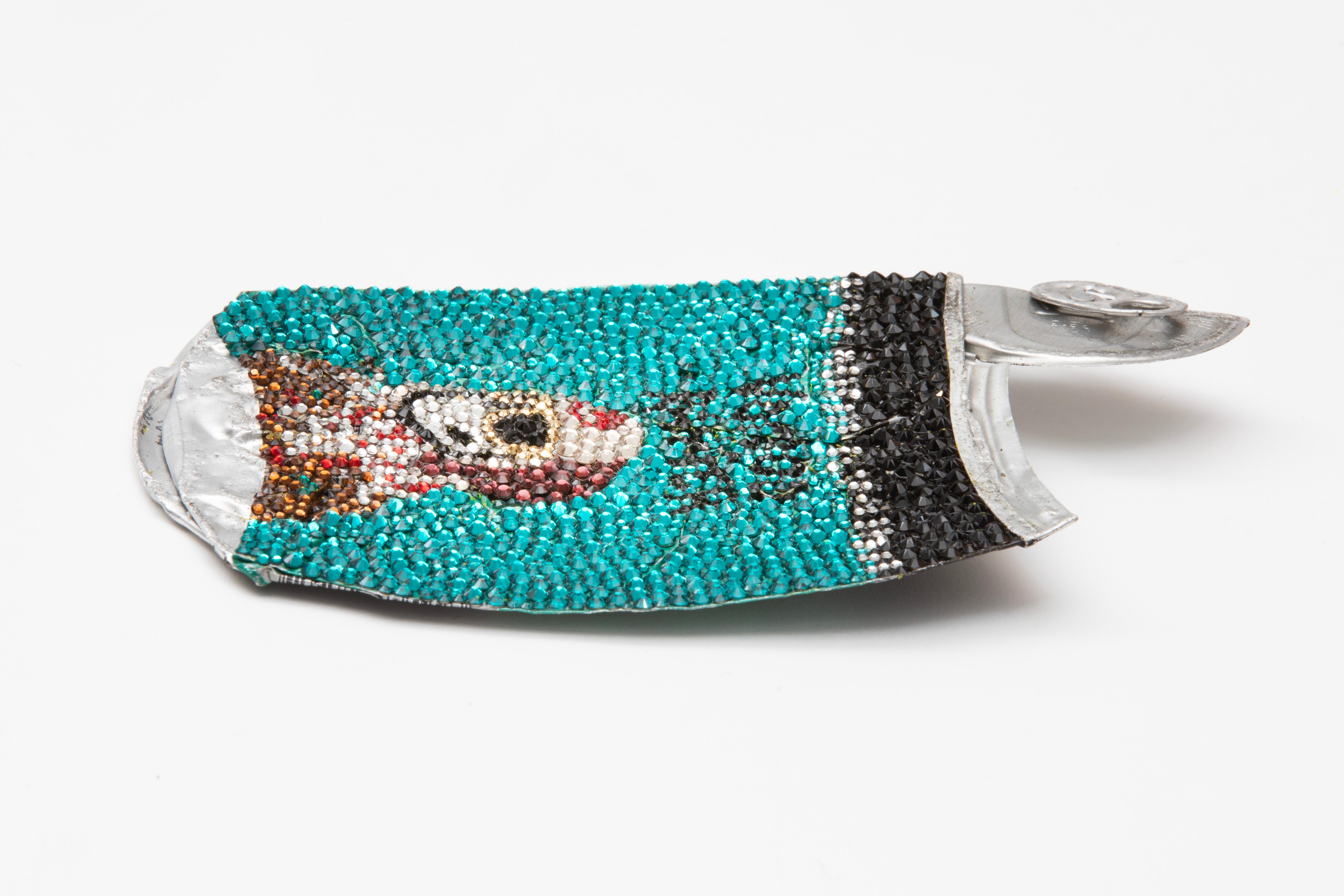 Sculpture made from Swarovski crystals and a found, car-flattened “Voodoo Ranger Imperial IPA” beer can by Los Angeles-based artist Sam Keller. The backside is signed and features a D-ring anchor for hanging. This piece was featured in Sam Keller's