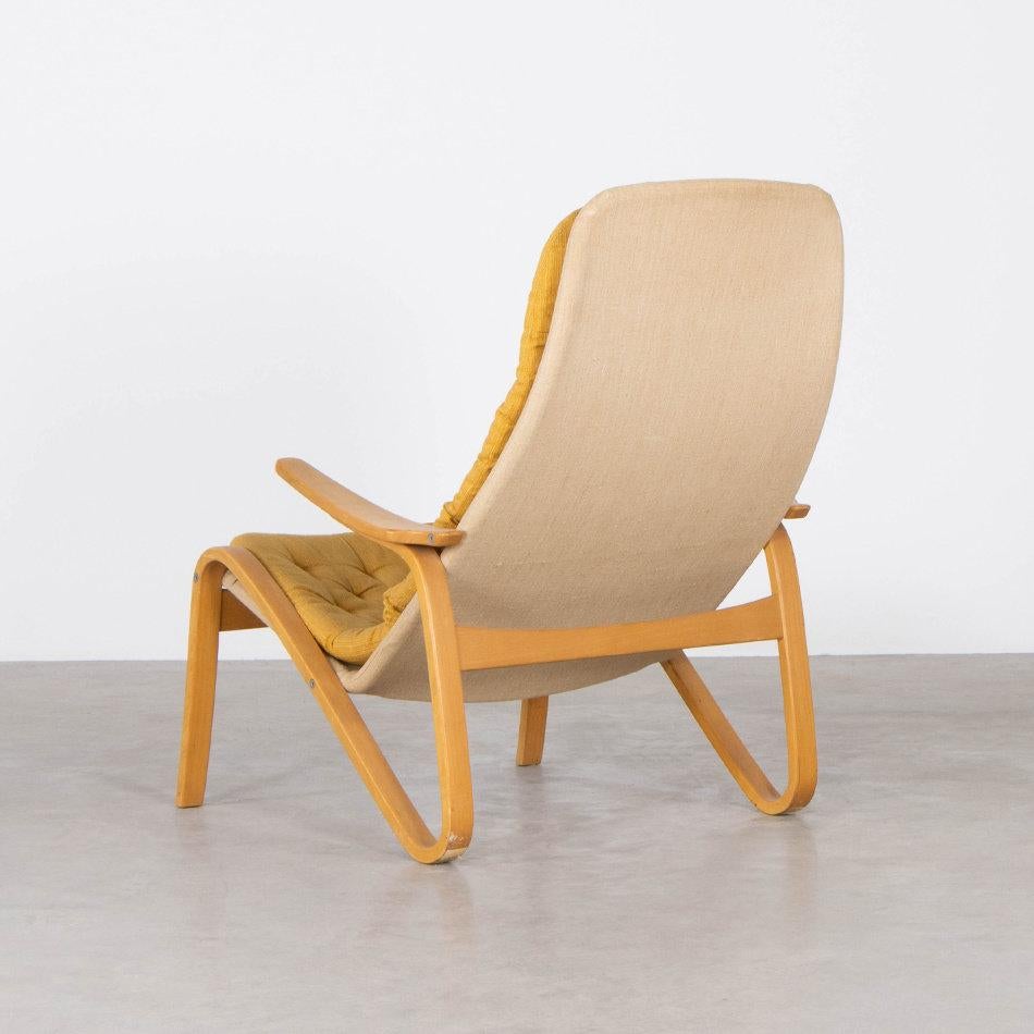 Nice lounge chair (Metro) designed by Sam Larsson for DUX Sweden. Birch plywood frame with canvas cover and cushions with ochre fabric. All in good original condition.