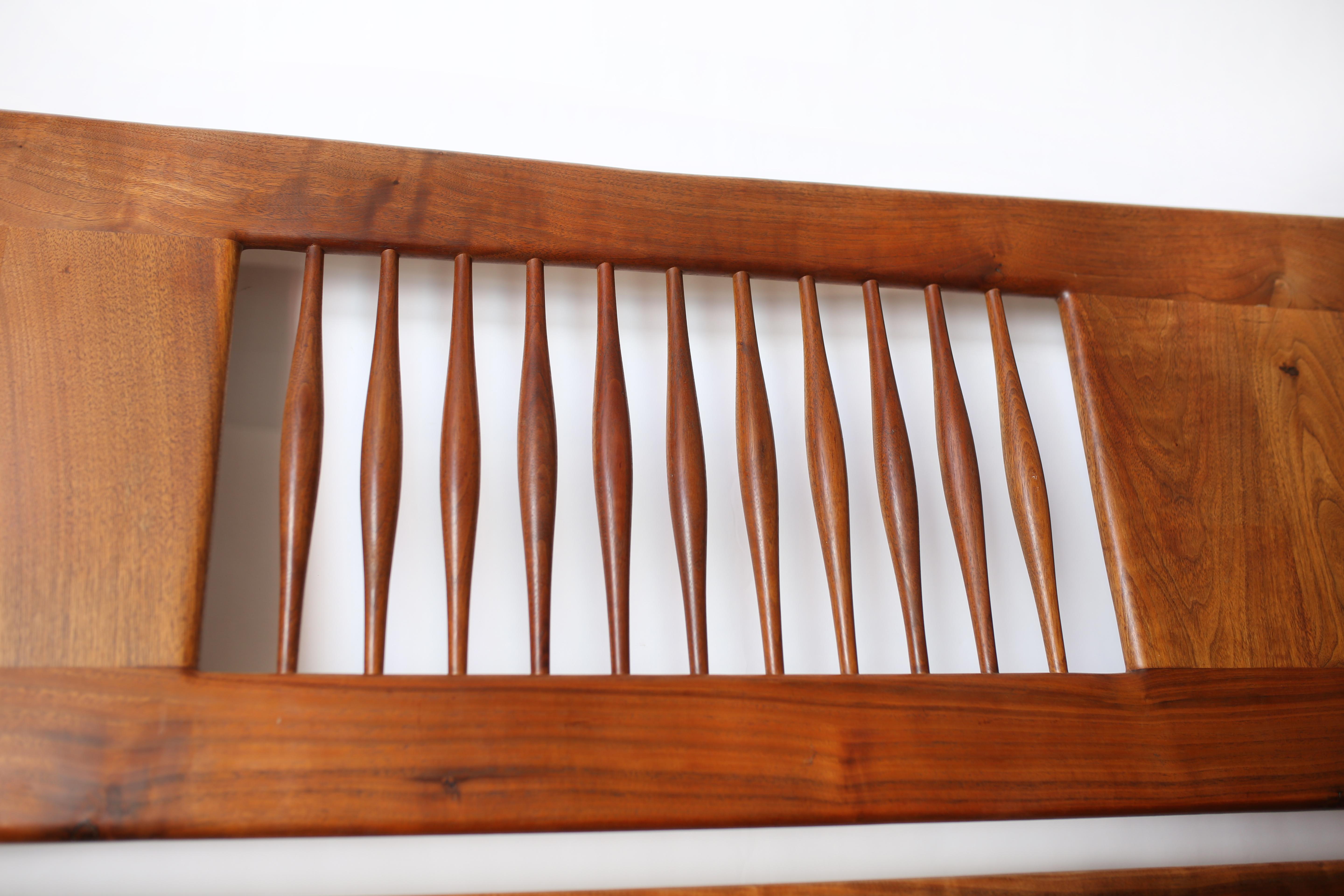 Sam Maloof is America's most renowned contemporary furniture designer and woodworker. This Sam Maloof black walnut spindle back king headboard is in overall good condition and wear consistent with age and use. Expertly crafted. Classic and