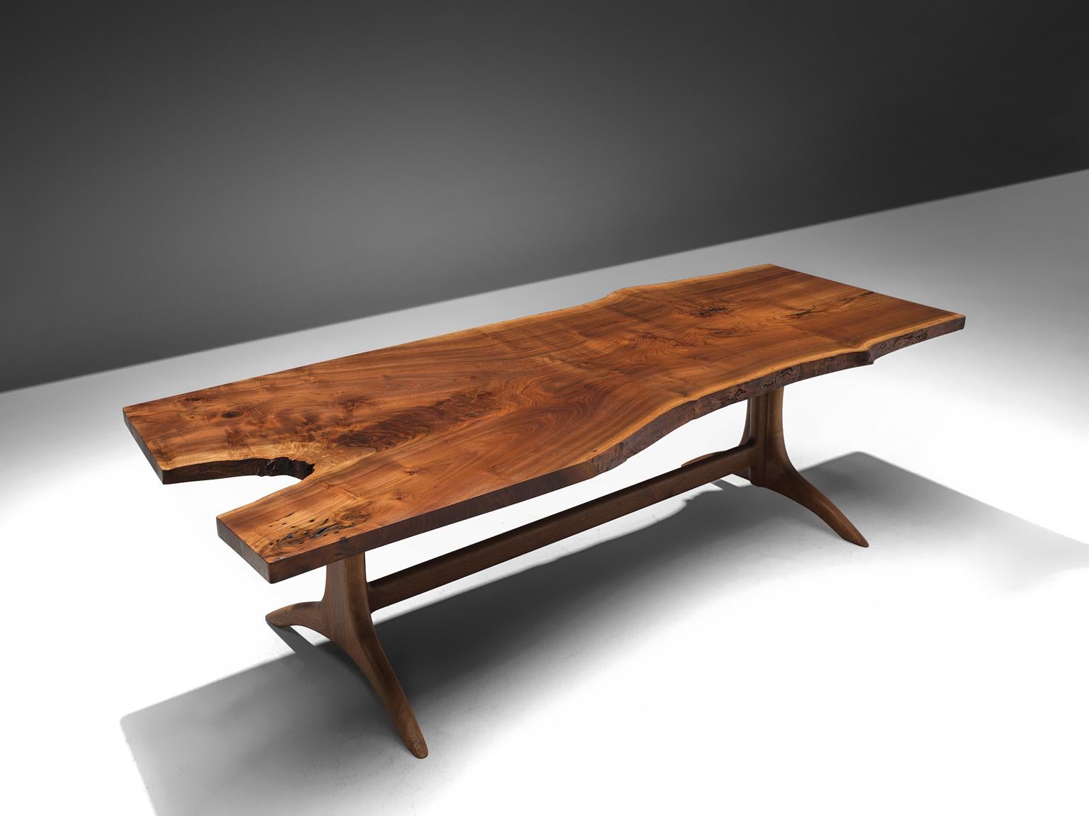 This sculptural piece by Maloof is hand and custom made and unique. The wood, Californian black walnut, is handpicked by Maloof himself. The piece is, just as other piece by Maloof a sculptural, timeless, high-quality wooden piece. This table he