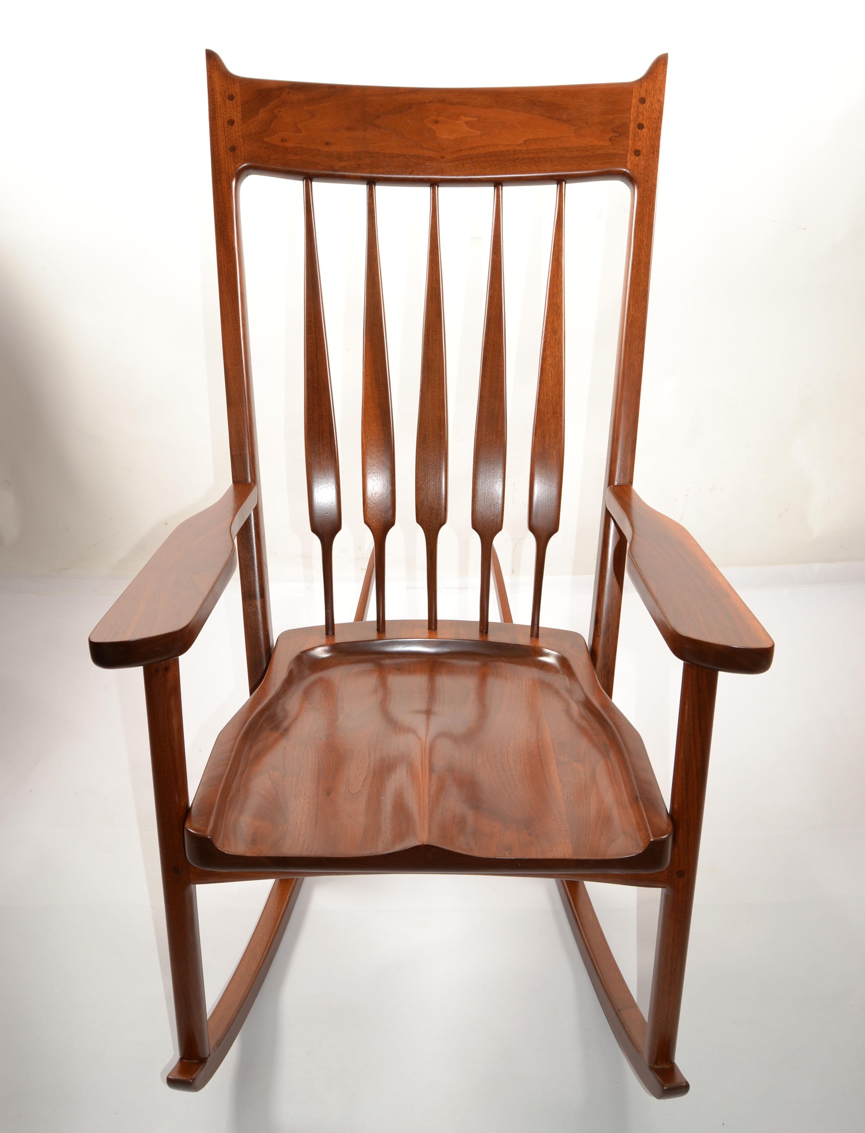 Sculptural handcrafted Walnut Rocking Chair by Artist Wharton Esherick attributed to Sam Maloof made in America circa early 1980s.
Featuring very long sleigh legs, dark Walnut Wood carved into a piece of Art.
Form fit Seat and Spindel Backrest for