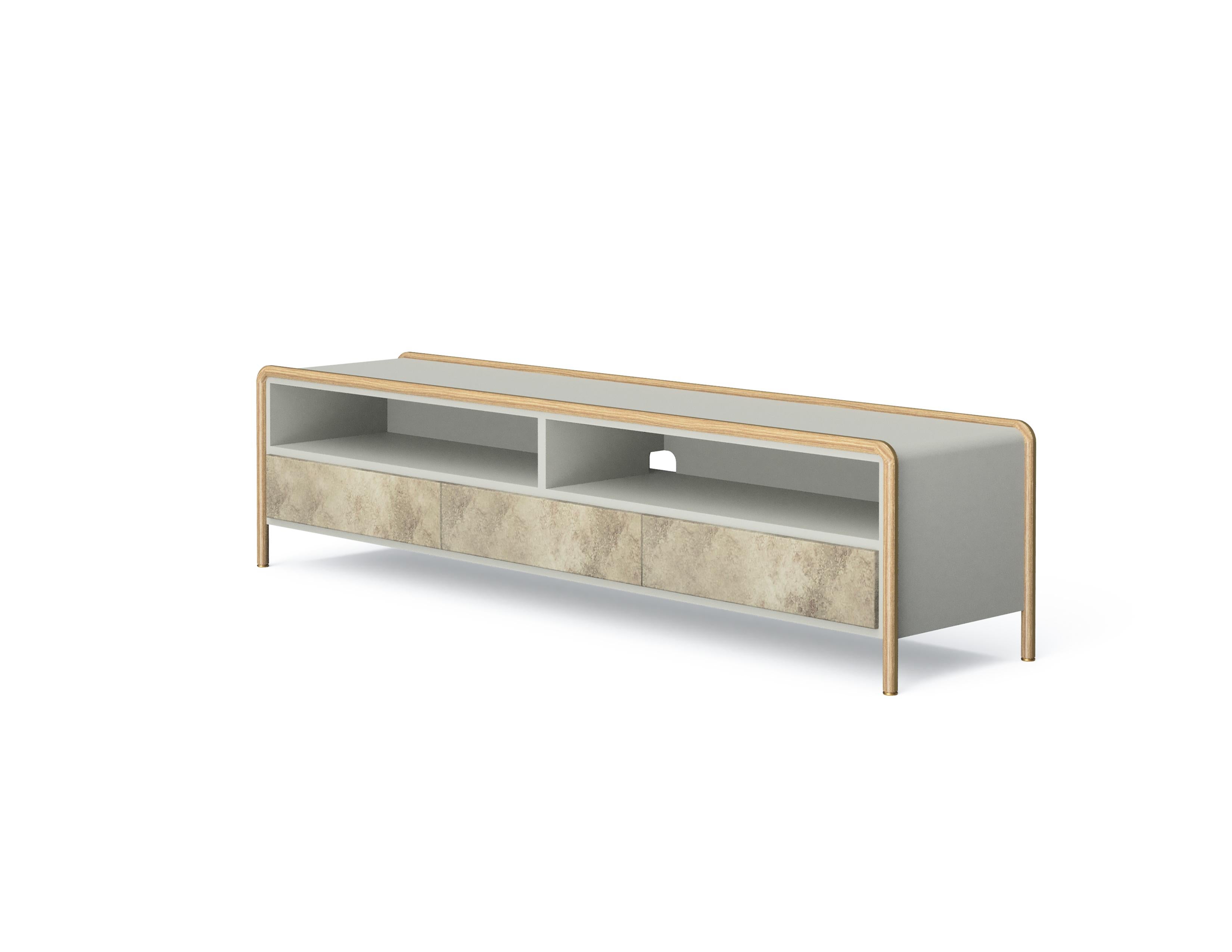 Manufactured using the woodturning technique, the solid wood , gently wraps around the top of the unit and come down to form the unit’s feet. The lacquered body adds serenity to ‘Sam’, which has versions with drawers and sliding doors.
‘Sam TV