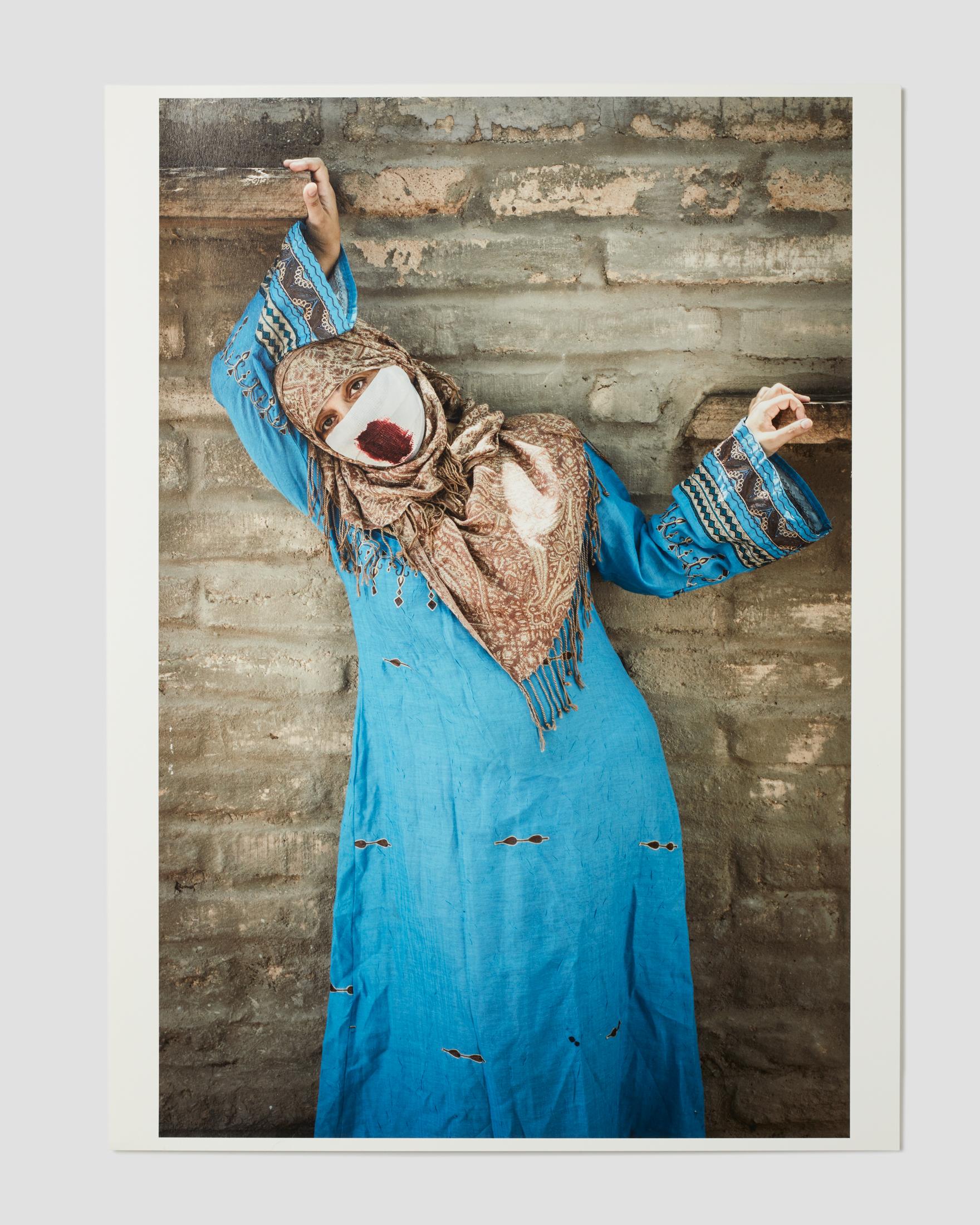 Sama Alshaibi Figurative Print - The Hanging Marionette