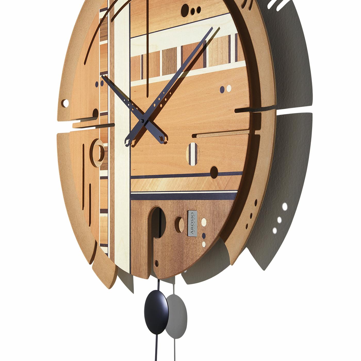 A functional work of art, this clock boasts a handmade face with a structure in wood pulp and a surface enriched with inlays of beechwood, maple, wenge, Canaletto walnut, and Italian walnut with a natural matte finish. Easy to read, this wall clock