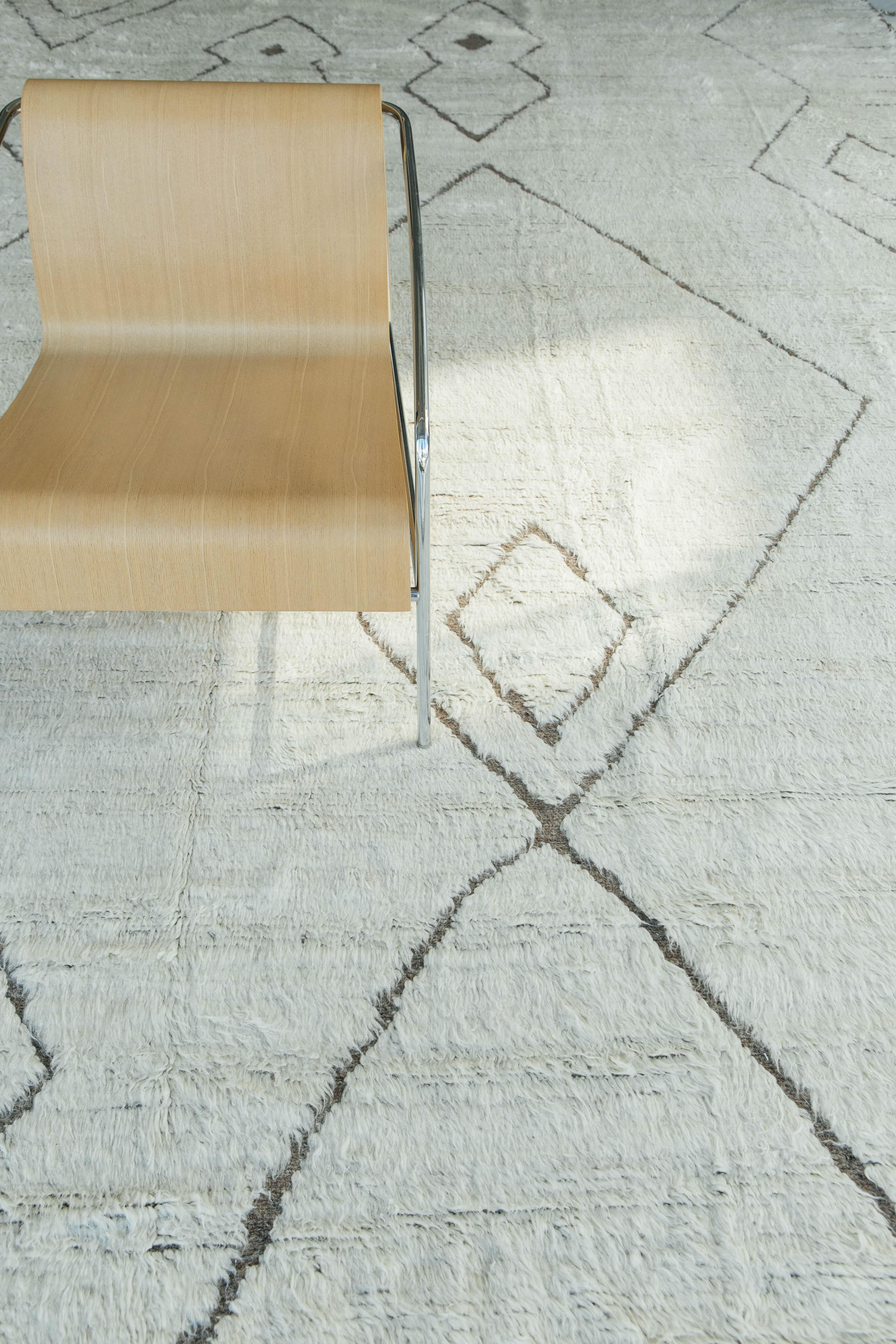 'Sambas' is a contemporary interpretation of an Azilal tribal rugs from Morocco. They are noted for their hand-spun wool, saturated color, intuitive motifs and charmingly irregular surface. Created with the perfect shade of white shag, taupe