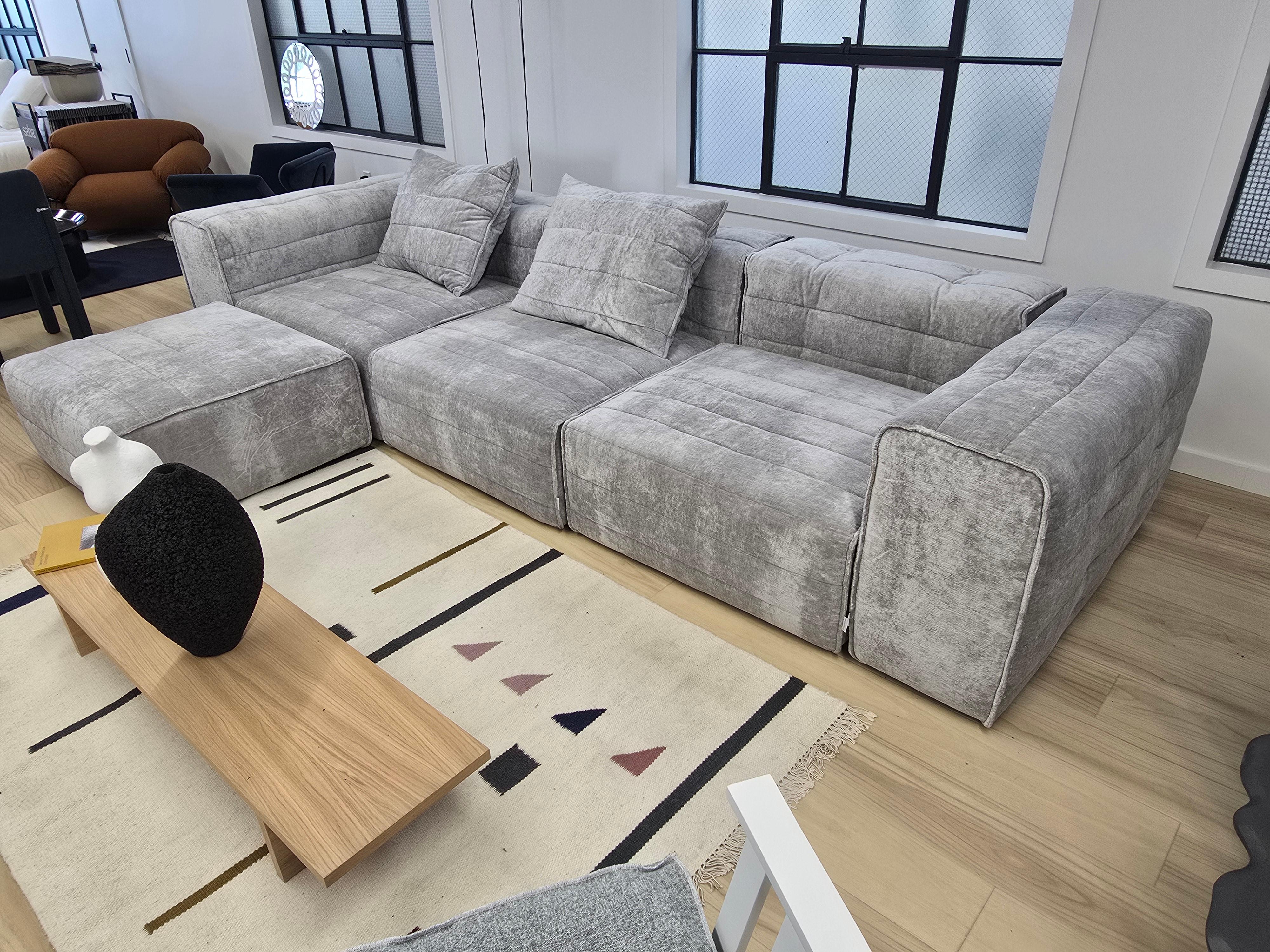 Modular sofa upholstered in polyurethane foam, removable cover. 

The 4 seating and 5 back and armrest units make it possible to build many different versions of this sofa that fits many different spaces. Very comfortable, more on the soft side with