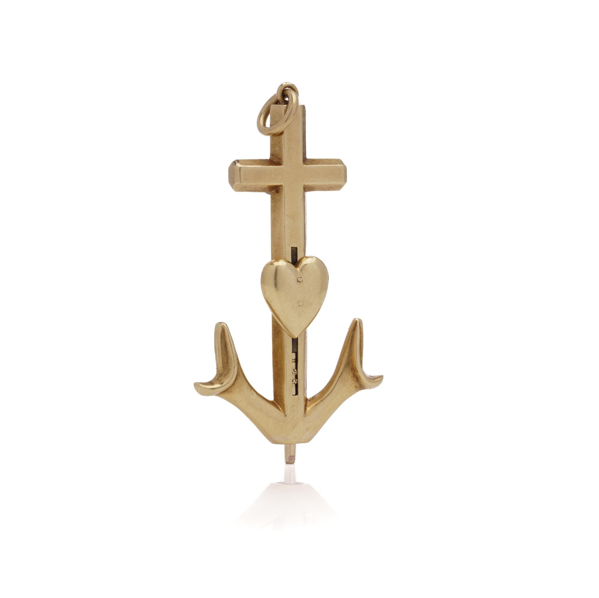 Victorian 18kt yellow gold pendant featuring an anchor, cross, and heart motif, symbolizing faith, hope, and charity respectively. The pendant doubles as a propelling pencil, with a convenient slide-action mechanism for opening. Complete with an