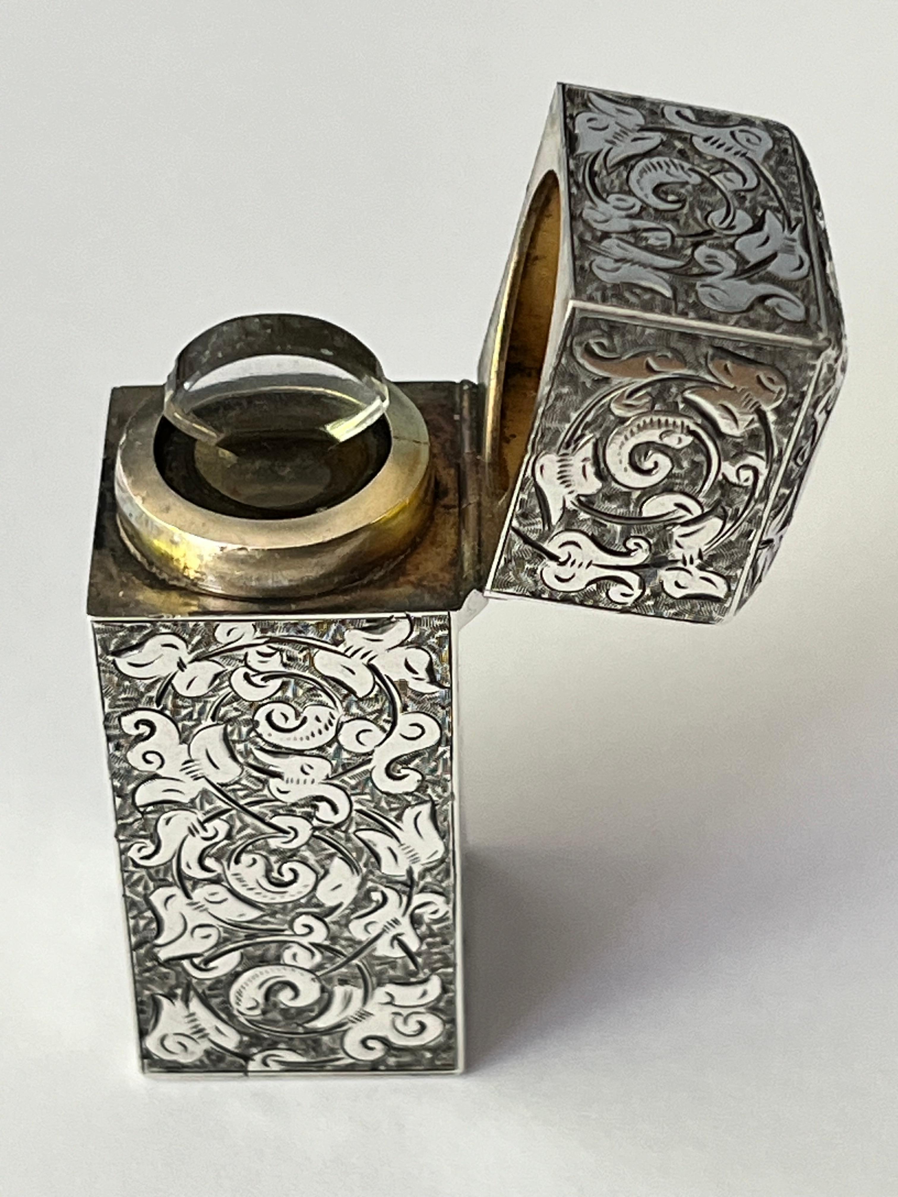 A fine quality and exceptional Victorian sterling silver scent or perfume bottle flask, of rectangular form, the hinged cover with domed paneled top, the exterior with all-over engraved and chased decoration depicting concentric circles of foliate