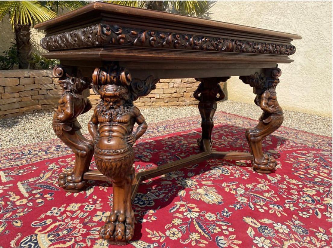 Exceptional richly carved walnut center table in Renaissance style. It rests on 4 feet representing the biblical legend of Samson and the Lion. 