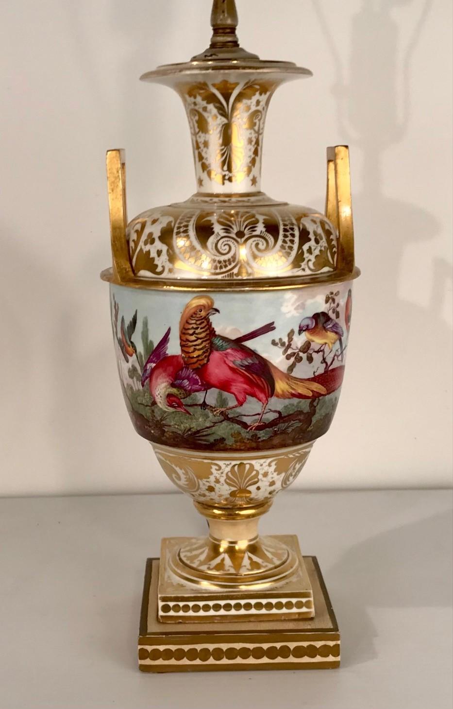 This lamp is both highly decorative and useful. It is by Samson, hard paste, unlike Derby and is spuriously marked Derby. As is sometimes the case, the bird painting is of excellent quality, The handles which are giltwood are very much in the Empire