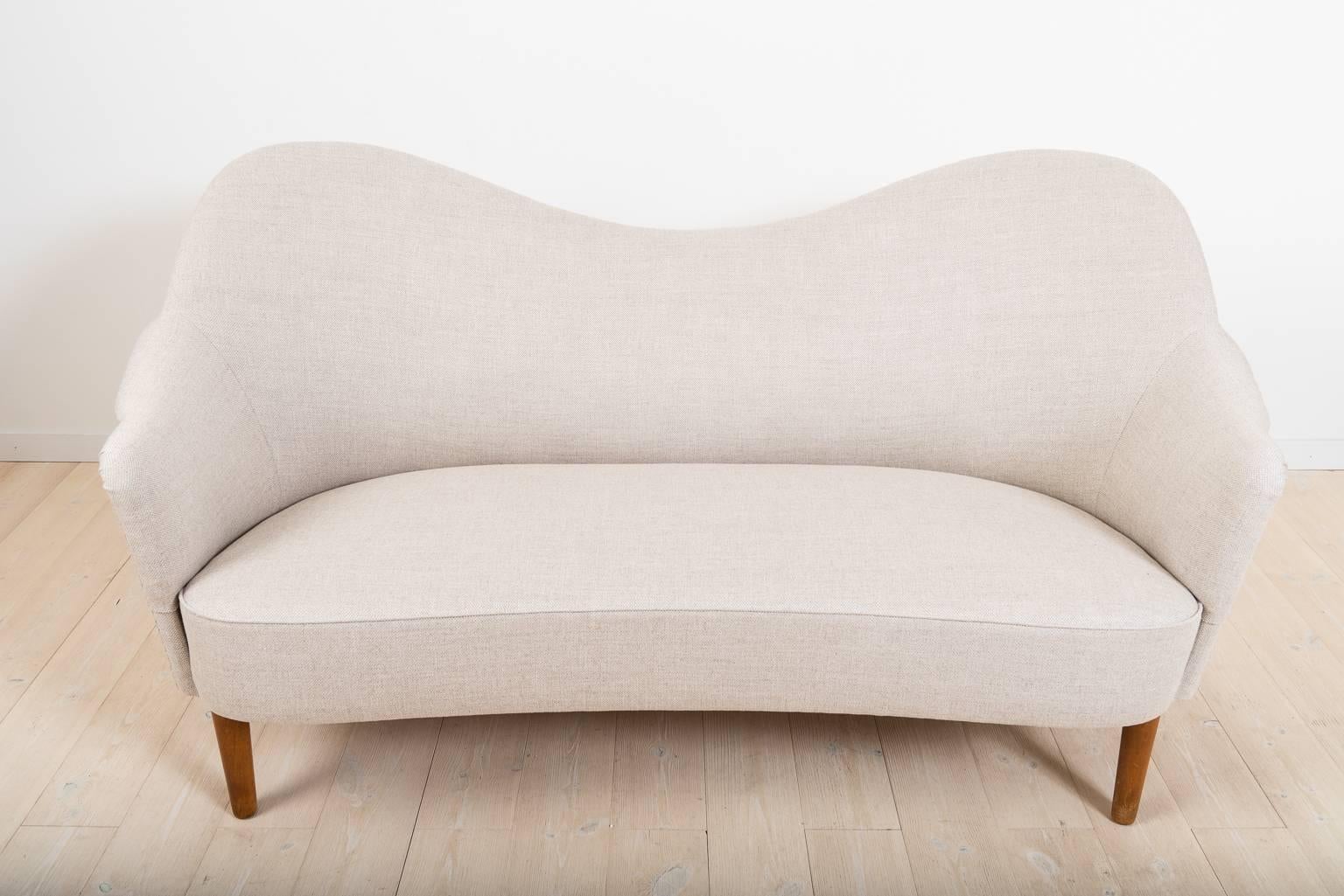 The model was designed 1956. The sofa has a completely renovated padding in traditional natural materials - no foam rubber has been used and new fabric.