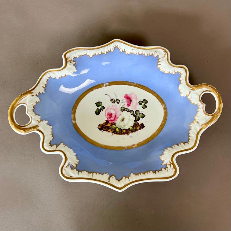 A two-handled leaf shaped dish with white melted snow border on a periwinkle ground, and a beautifully painted bouquet of pink and white roses in the centre

There are several other items available in near-identical style, see separate