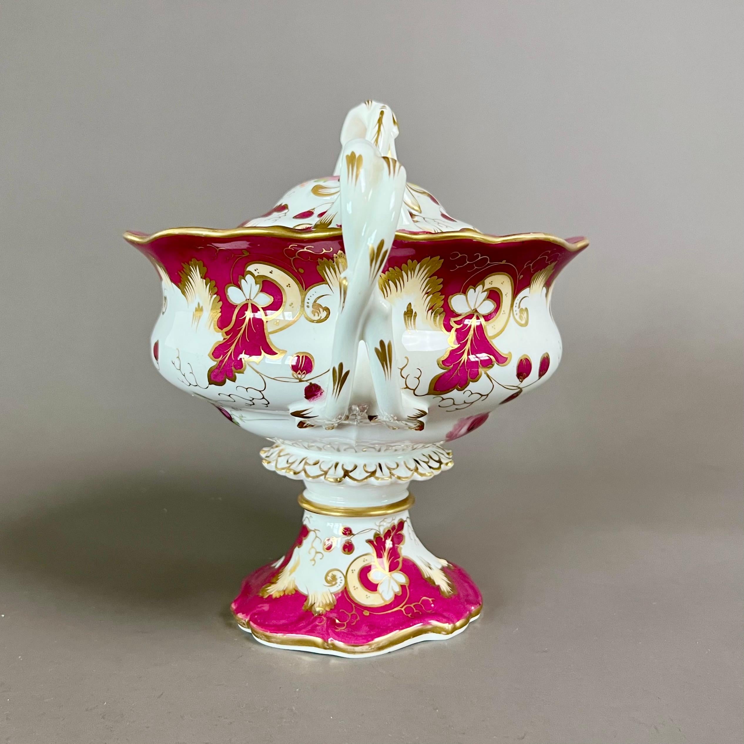 A footed two-handled sauce tureen with cover, maroon and pale yellow ground with beautiful hand painted flower sprays on lower part of body; twisted handles and a petticoat stem

Pattern 2/817
Year: ca 1842
Size: 20cm tall incl. finial
