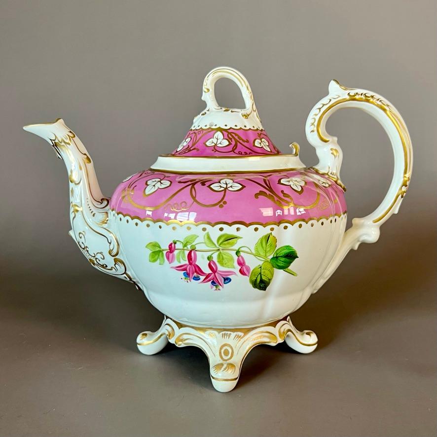 A matched solitaire tea set consisting of a teapot with cover, a sucrier with cover, a milk jug and a matched trio consisting of a teacup, a coffee cup and a saucer. With pink ground and looping vines, and hand painted flowers

Patterns 1/6600 and