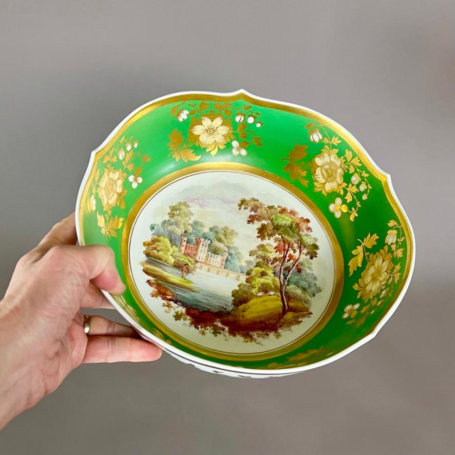 A stunning and very rare large punch bowl in a variation on the writhen shape, emerald green ground with large flower sprays in white and gilt, and a freely painted landscape of sublime quality in the centre

Pattern 1150
Year: ca 1826
Size: 27.2cm