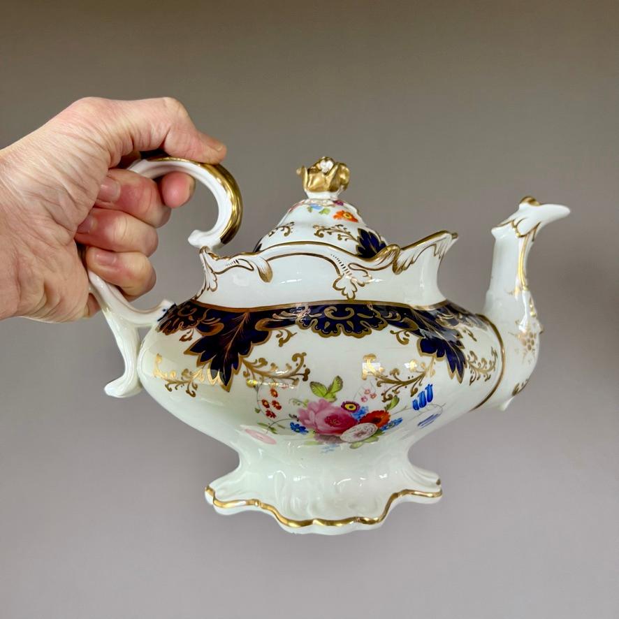 A teapot with cover in the “rustic bean” shape, cobalt blue ground with gilt acanthus motif and finely painted flower posies on the belly of the teapot

Pattern 5782
Year: ca 1837
Size: teapot 25cm (10.25”) from handle to spout
Condition:
