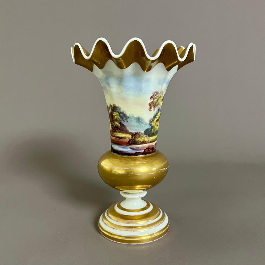 An extremely rare wave edge vase on a round foot with superb continuous landscape painting of a river scene with ruins and two figures, rich gilding on the upper edge, ball and foot.

Pattern 1077
Year: ca 1826
Size: 18.5cm tall (7.25”)
Condition: