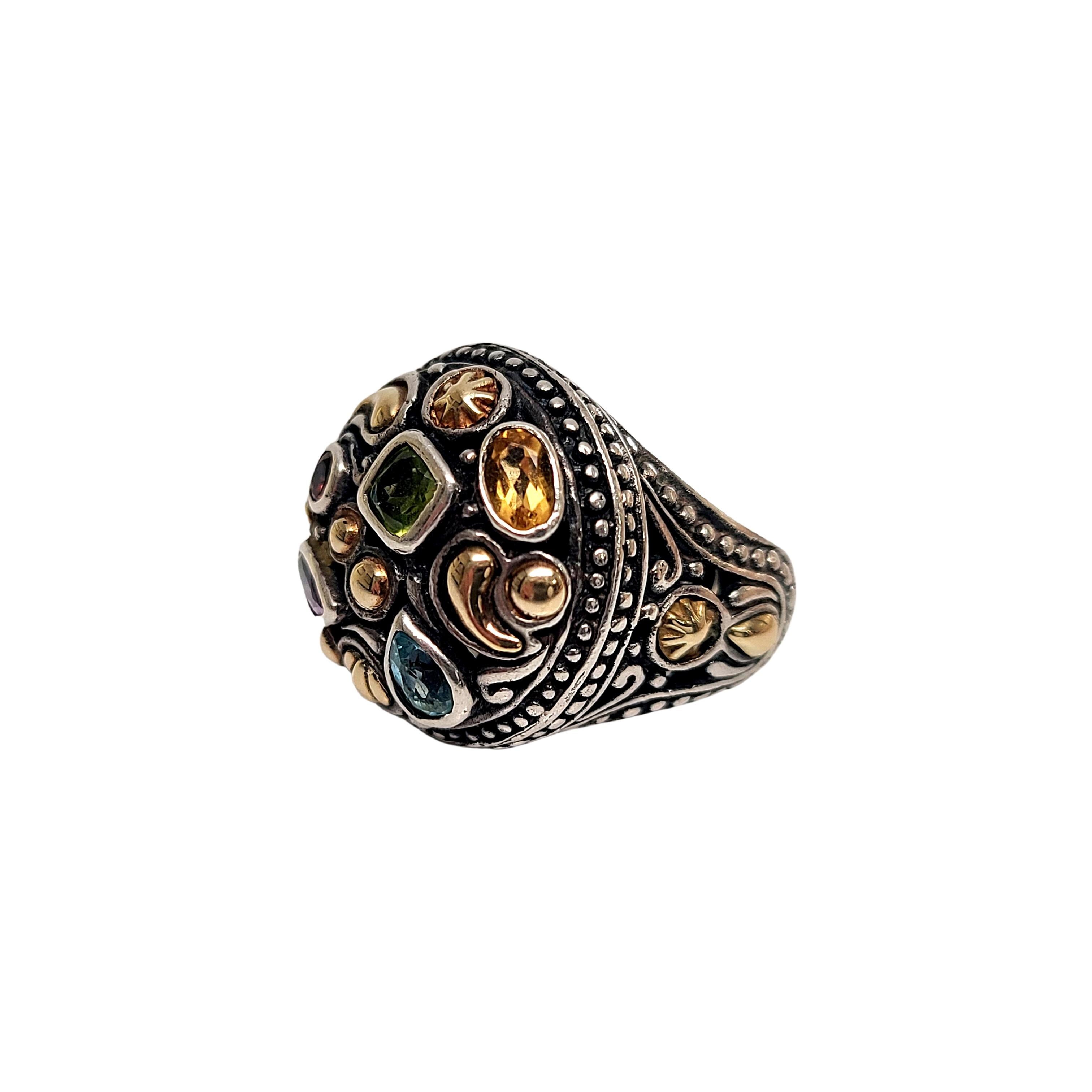 Sterling silver and multi-gemstone ring by designer Samuel Benham, signed BJC.

Size 5 1/2

Sterling silver ring featuring 18K gold plated over sterling silver accents on the top and shoulders. Stone appear to by amethyst, peridot, blue topaz,