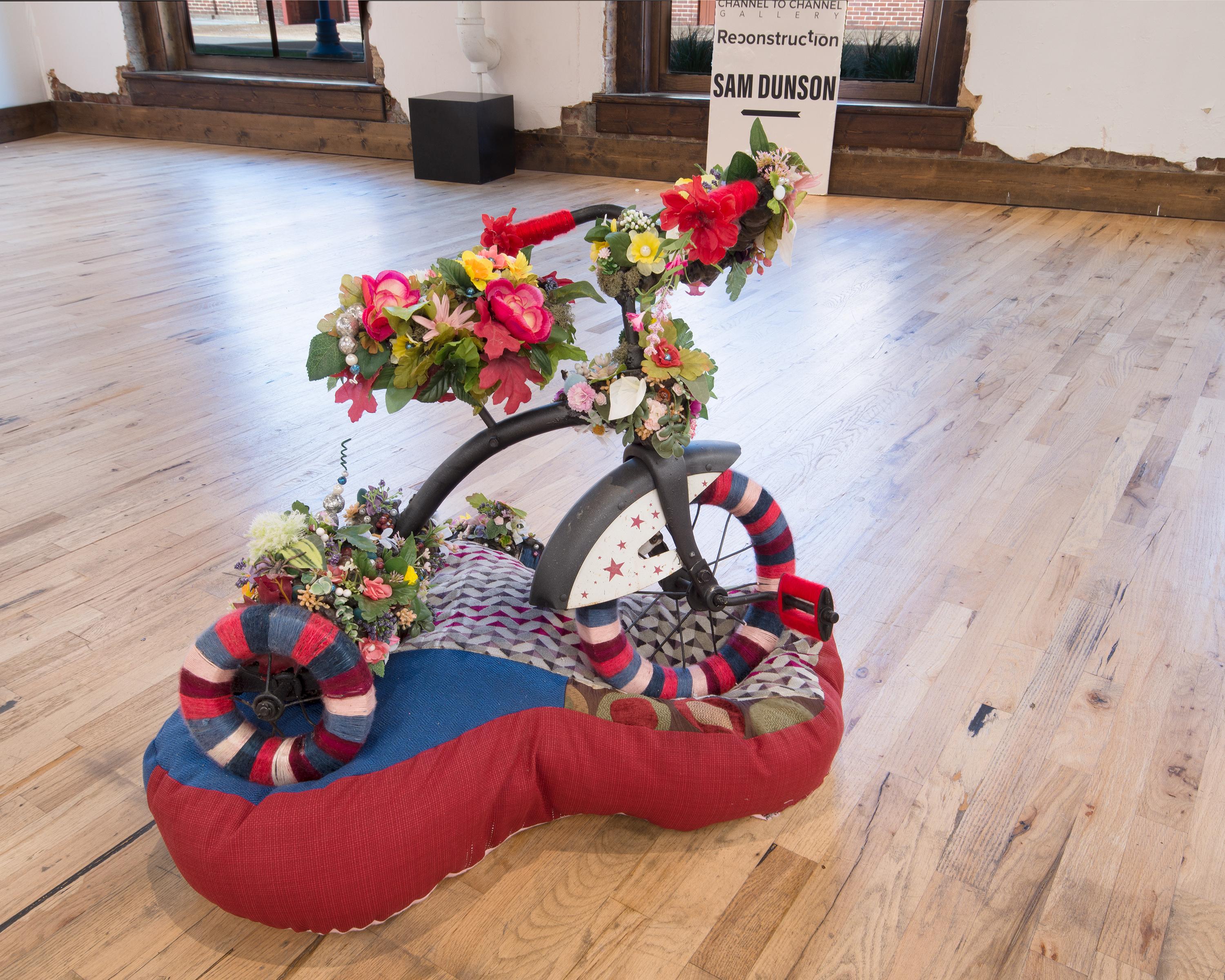 MAKE AMERICA GREAT AGAIN - Tricycle from the 40s adorned w/ Flowers on Cushion - Contemporary Mixed Media Art by Samuel Dunson