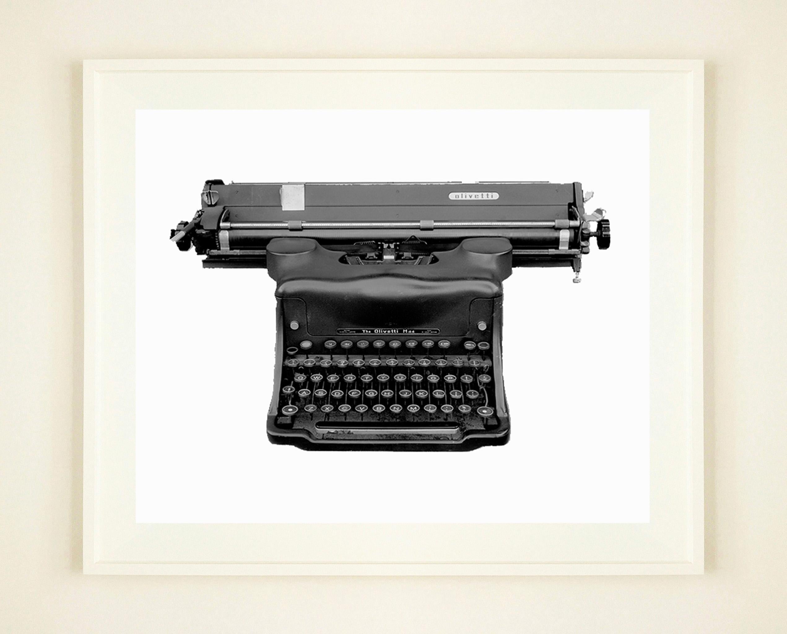 Samuel Field's still life of an Olivetti Typewriter, is given depth in the orthochromatic process he has used. Isolated in monochrome you appreciate the details of this vintage utilitarian object. 

This artwork is a limited edition of 10 lustre