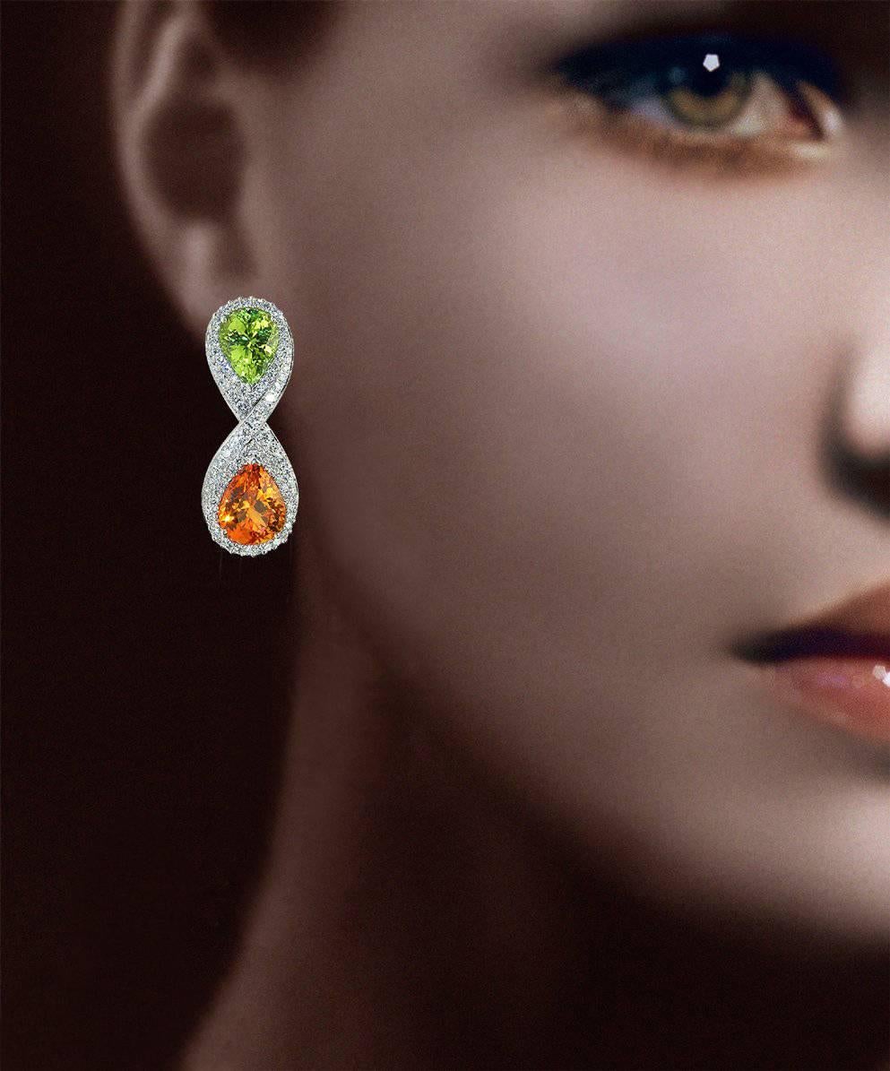 A Pair of "Samuel Getz" 18 Karat  White Gold Ear Clips Featuring a pair of Rare Pear Shape Neon Green Chrysoberyl, 5.87 Carats [3.02 ct., 10.35 x 7.97 x 5.78 mm., 2.84 ct., 10.38 x 7.93 x 5.53 mm.] [India], a pair of Pear Shape Mandarin
