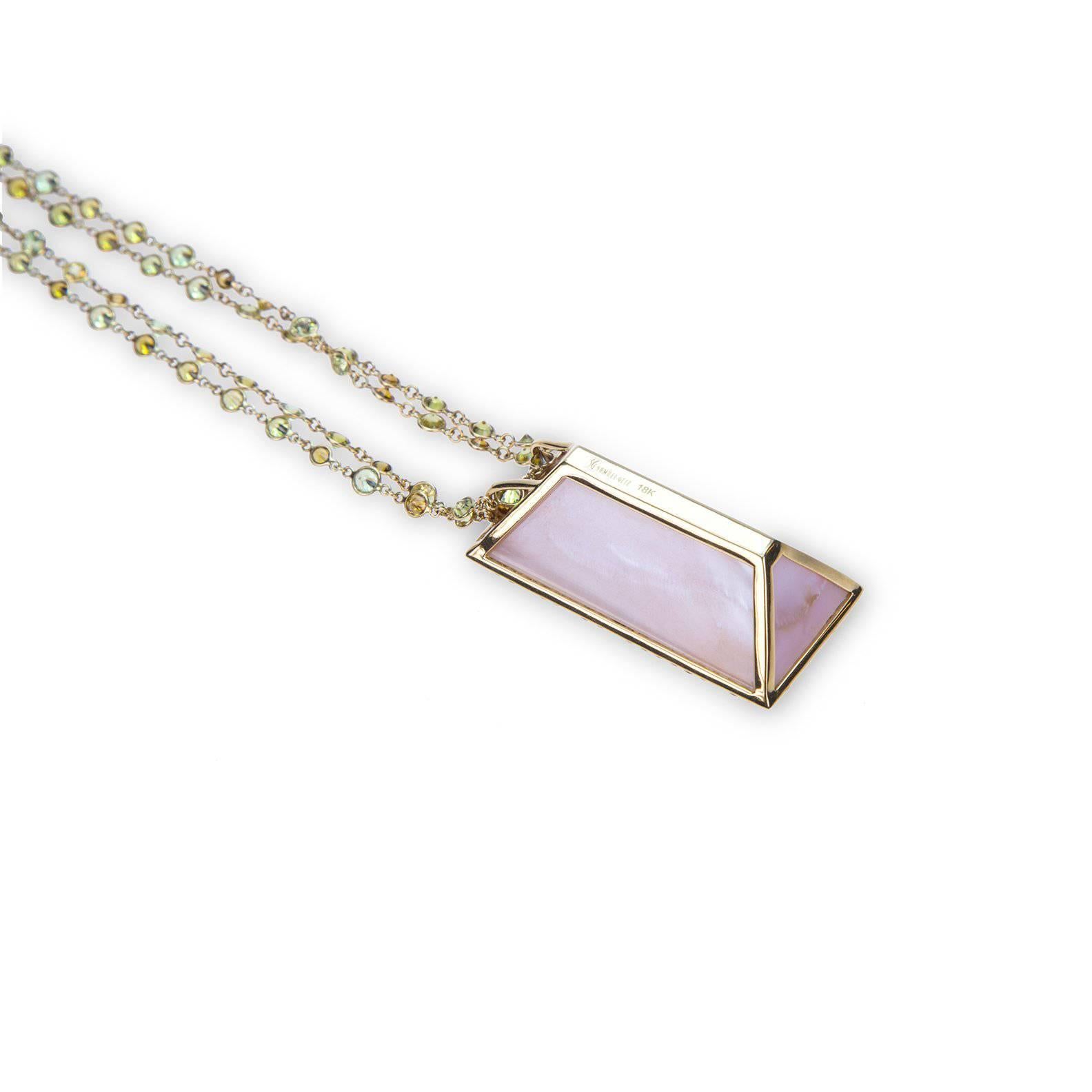 A "Samuel Getz" 18 Karat Yellow Gold Pendant Featuring a Rectangular Shape "Munsteiner" Cut, Phantom Quartz, 102.72 ct. [40.06 x 23.22 x 13.71 mm.], Mother of Pearl, and 64 Round Brilliant Cut Mali Garnets, 5.73 Carats. The