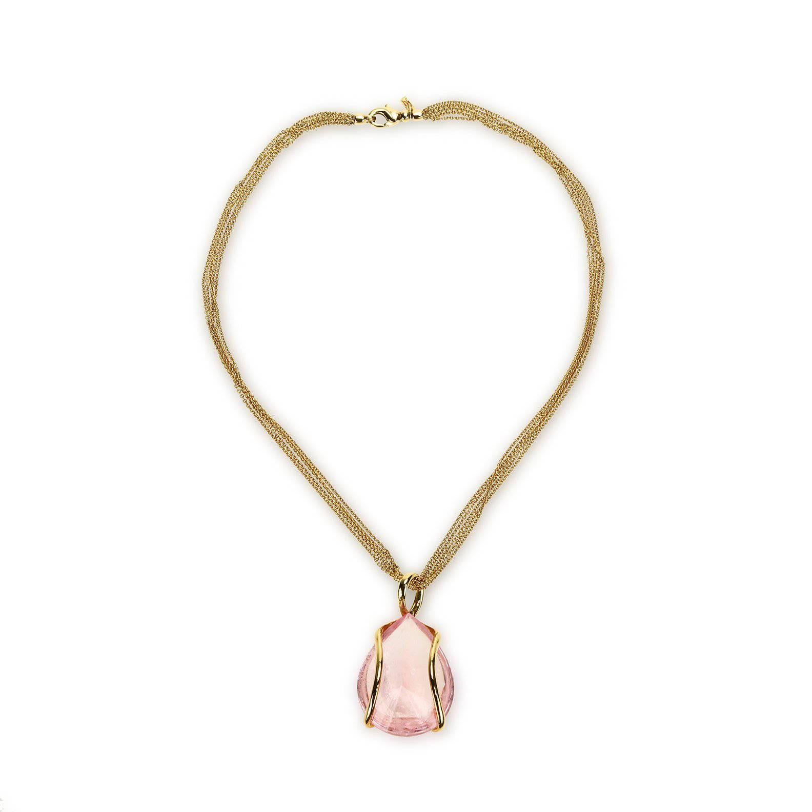 A "Samuel Getz" 18 Karat Yellow Gold Freestyle Pendant Featuring a Large Pear Shape Mirror Buff Cut Morganite, 109.49 Carats [39.26 x 30.63 x 18.84 mm.]. The Pendant is suspended on an 18 Karat Yellow Gold, 18 Inch, 5 Strand, Round Cable