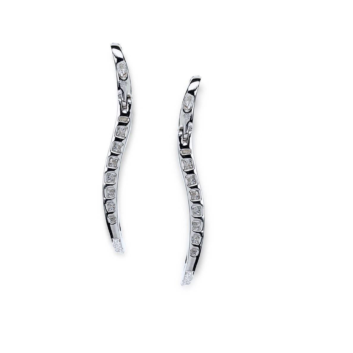 Pair of "Samuel Getz" 18 Karat White Gold Signature "S" Diamond Hoop Earrings Featuring [78] Graduated Pavé Set Round Brilliant Diamonds with an approximate Total Weight of 3.76 Carats of F Color and VS1 - VS2 Clarity.

The