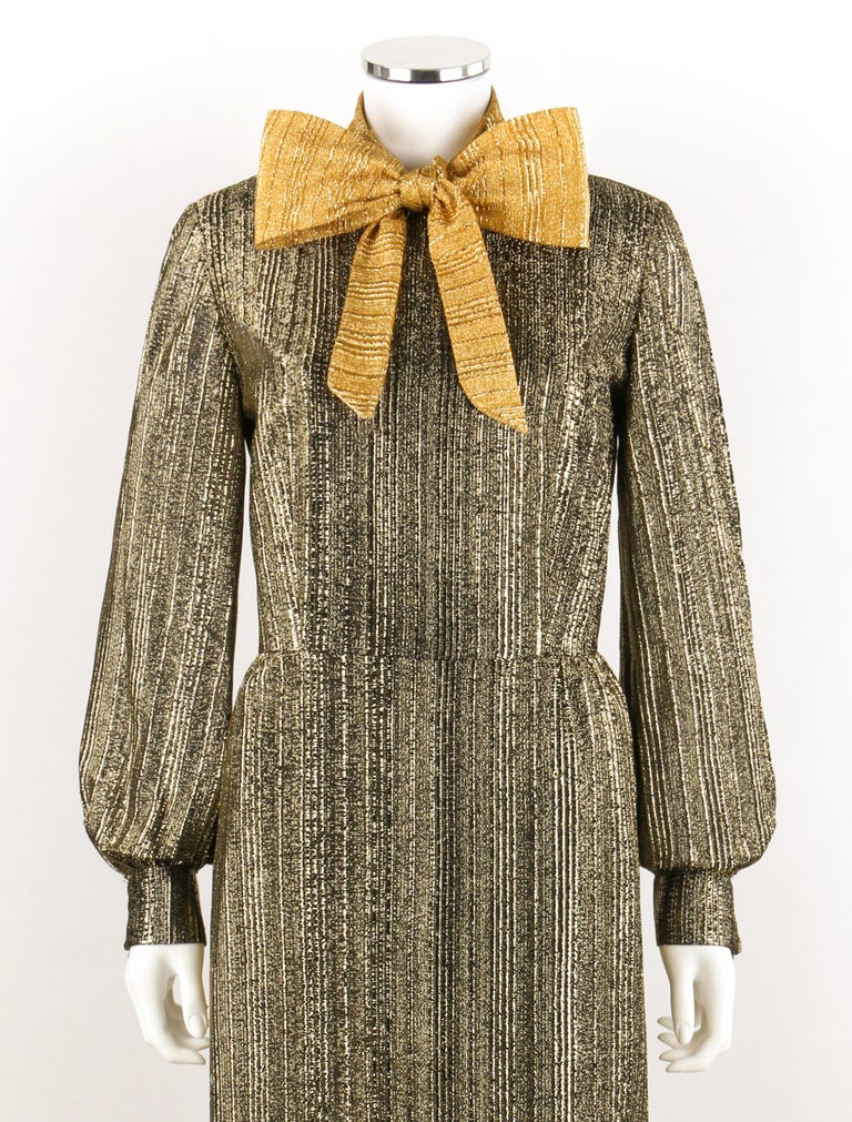 SAMUEL GROSSMAN c.1960s Black & Metallic Gold Bow Collar Maxi Sheath Dress Gown
 
Circa: 1960’s
Label(s): A Samuel Grossman Dress
Designer: Samuel Grossman
Style: Maxi dress / gown
Color(s): Shades of gold, black (exterior, interior)
Lined: