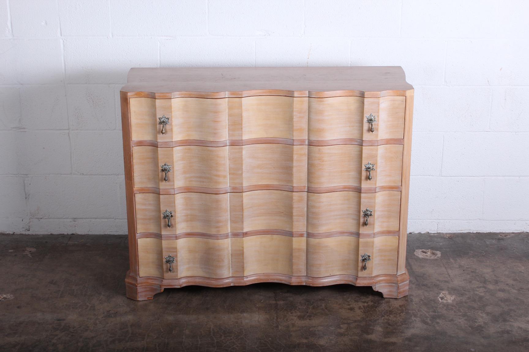 A beautiful four drawer dresser with cerused finished and brass hardware. Designed by Samuel Marx for Quigley.