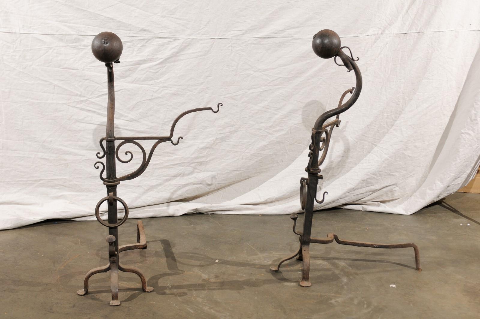 Samuel Yellin style pair of 20th century jumbo iron andirons with cooking arms
In the style of Samuel Yellin.