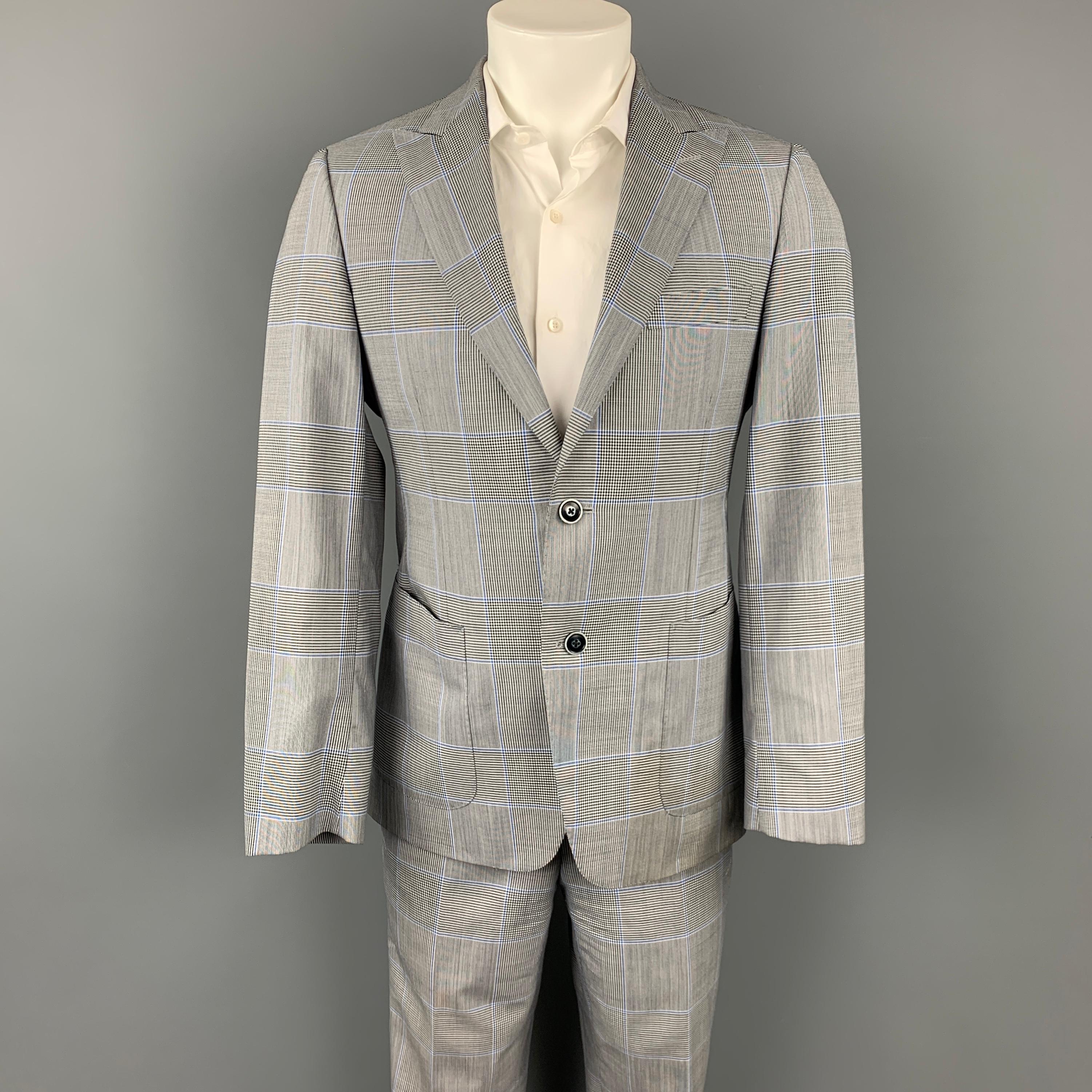 SAMUELSOHN for WILKES BASHFORD suit comes in a grey & blue glenplaid wool with a full liner and includes a single breasted, two button sport coat with a peak lapel and matching flat front trousers.

Very Good Pre-Owned Condition.
Marked:
