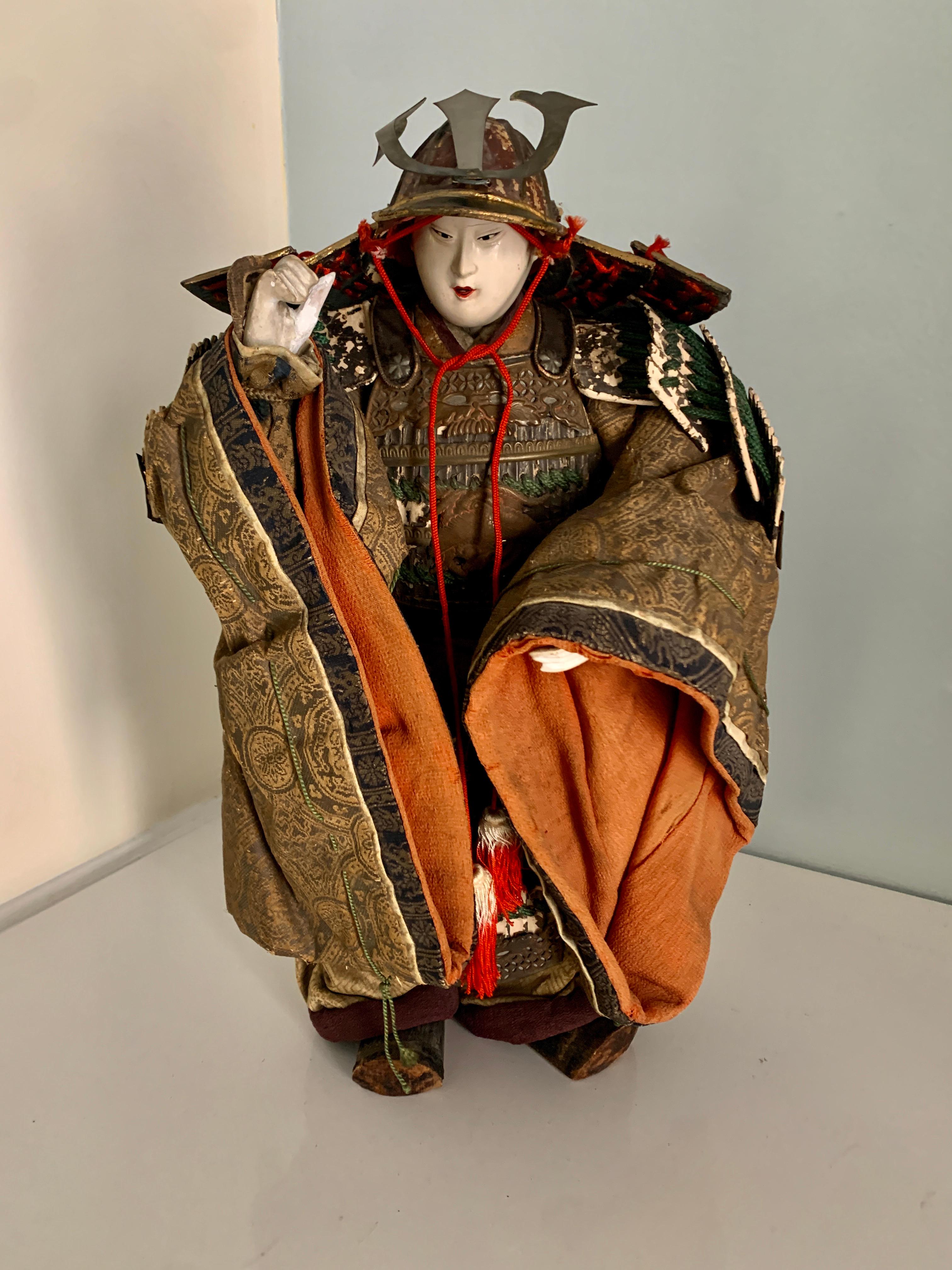 Samurai Warrior Japanese Figure - A vintage figure with full wardrobe in very intricate and well designed costume. The wardrobe is in good vintage condition, with woven silk and cotton fabrics, helmet in metal and interlaced cording. The piece is