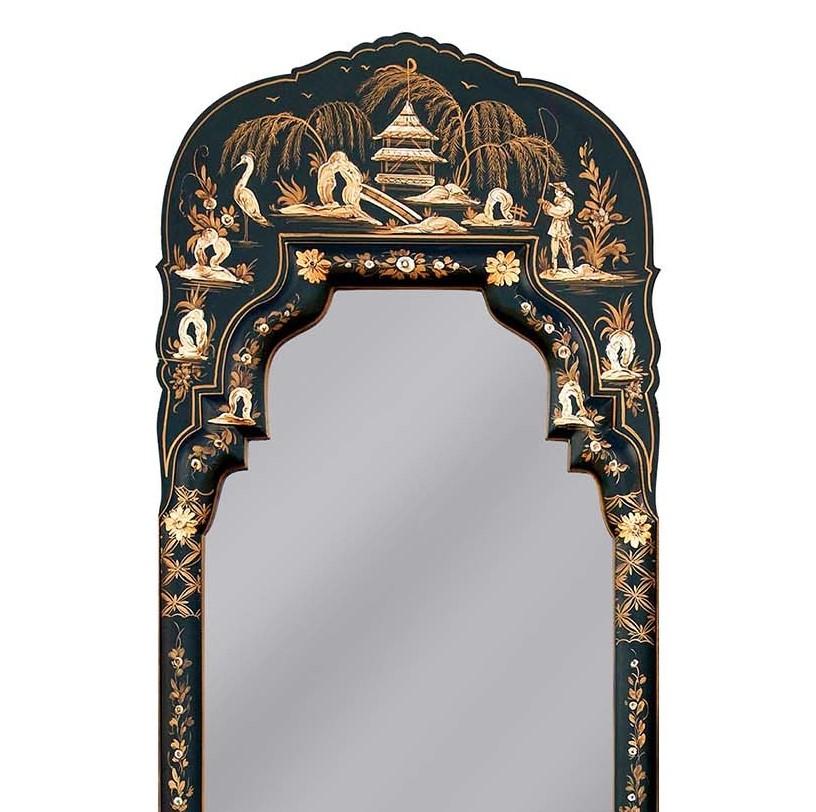 A magnificent addition to an elegant interior, this mirror is a unique work of art that will enrich any decor. Its elongated silhouette is enclosed in a wooden frame that was colored in San Polo black and adorned by hand with a series of fine floral