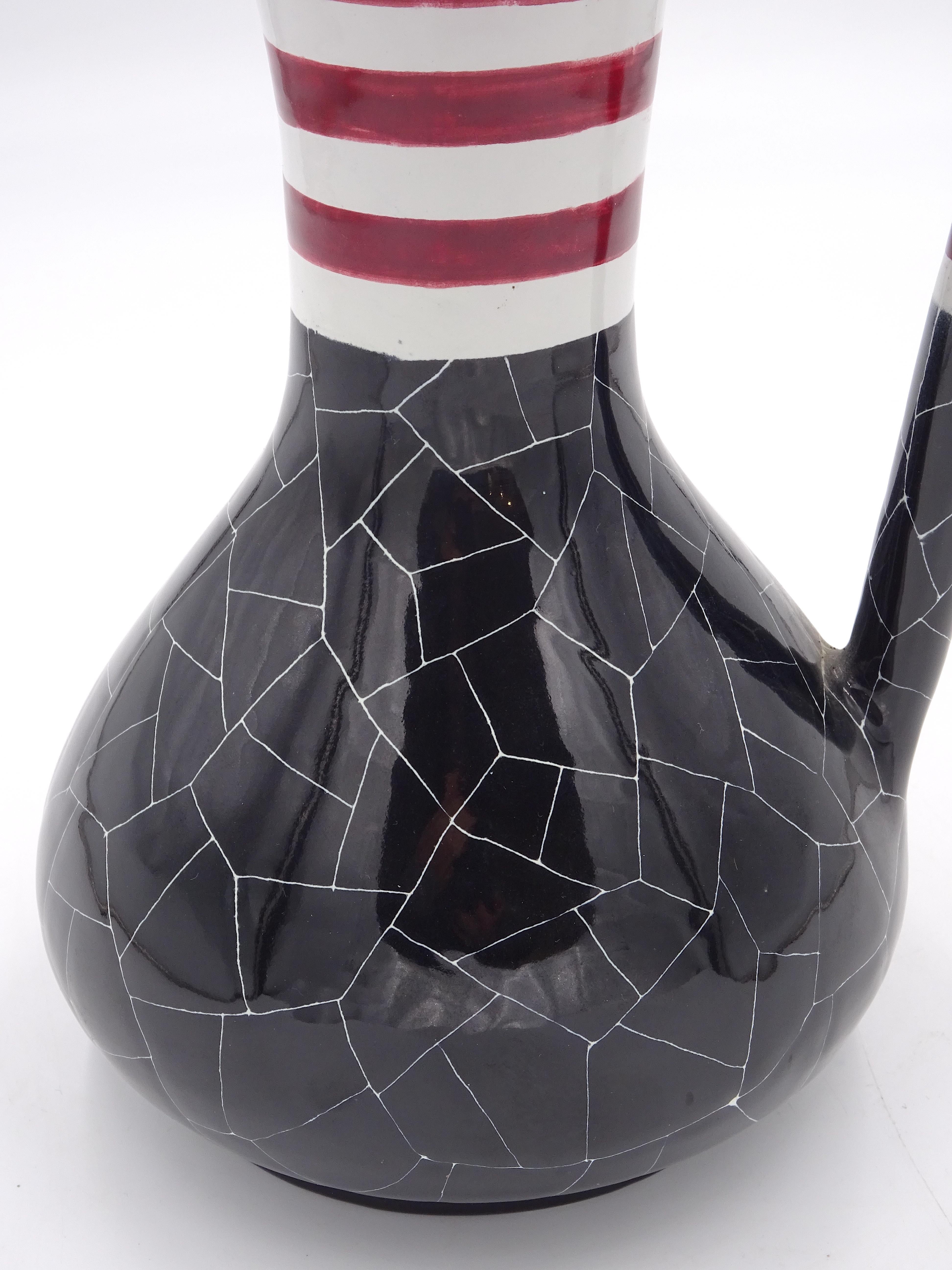 Pitcher made of ceramic by the Venetian manufacture San Polo around 1950s. The pitcher is black in color but distinguished by distinctive white veining, there is also a banded decoration on the neck of the pitcher and du part of the handle in red